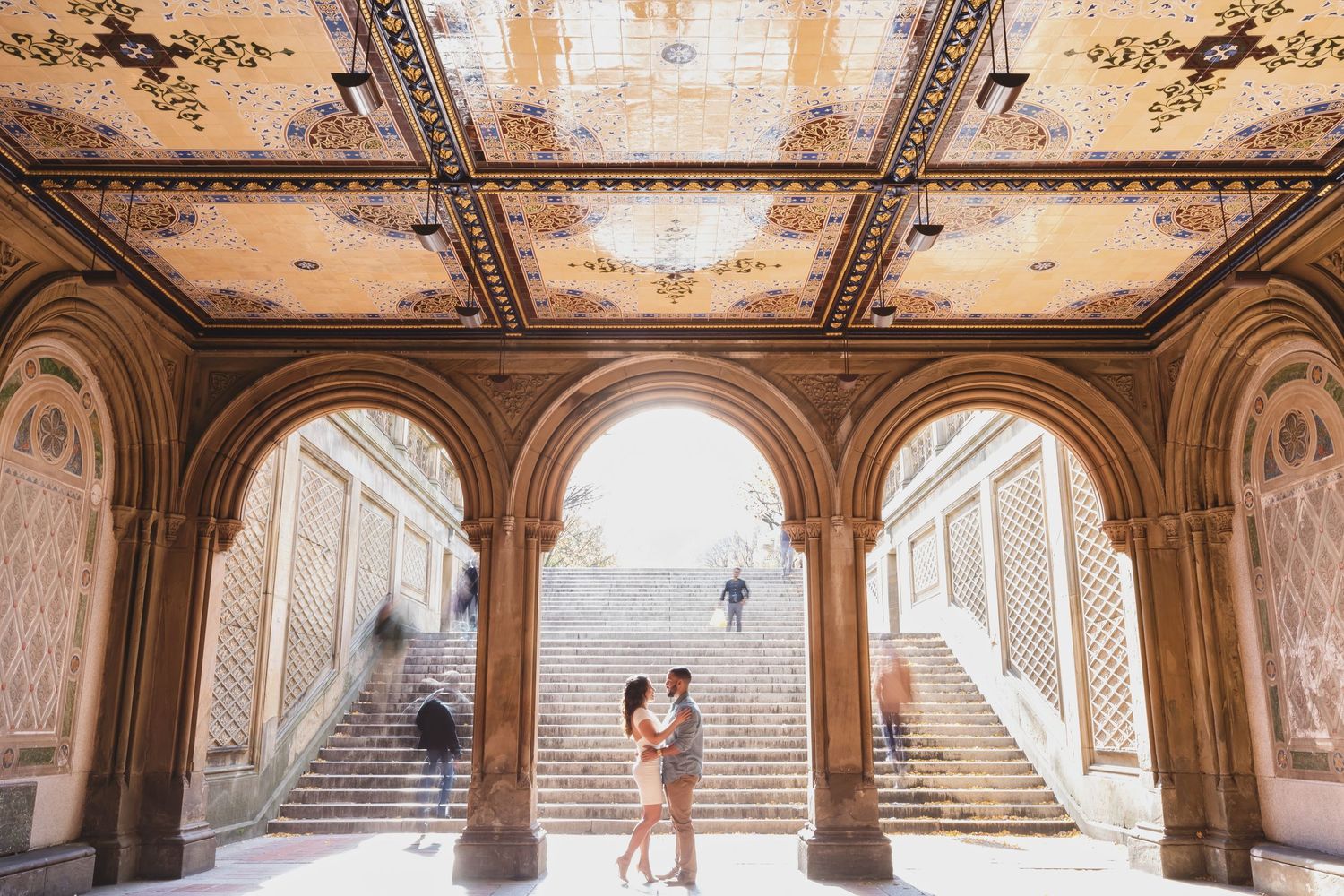 Romantic couple portraits in historic Bethesda Terrace archways in Central Park.