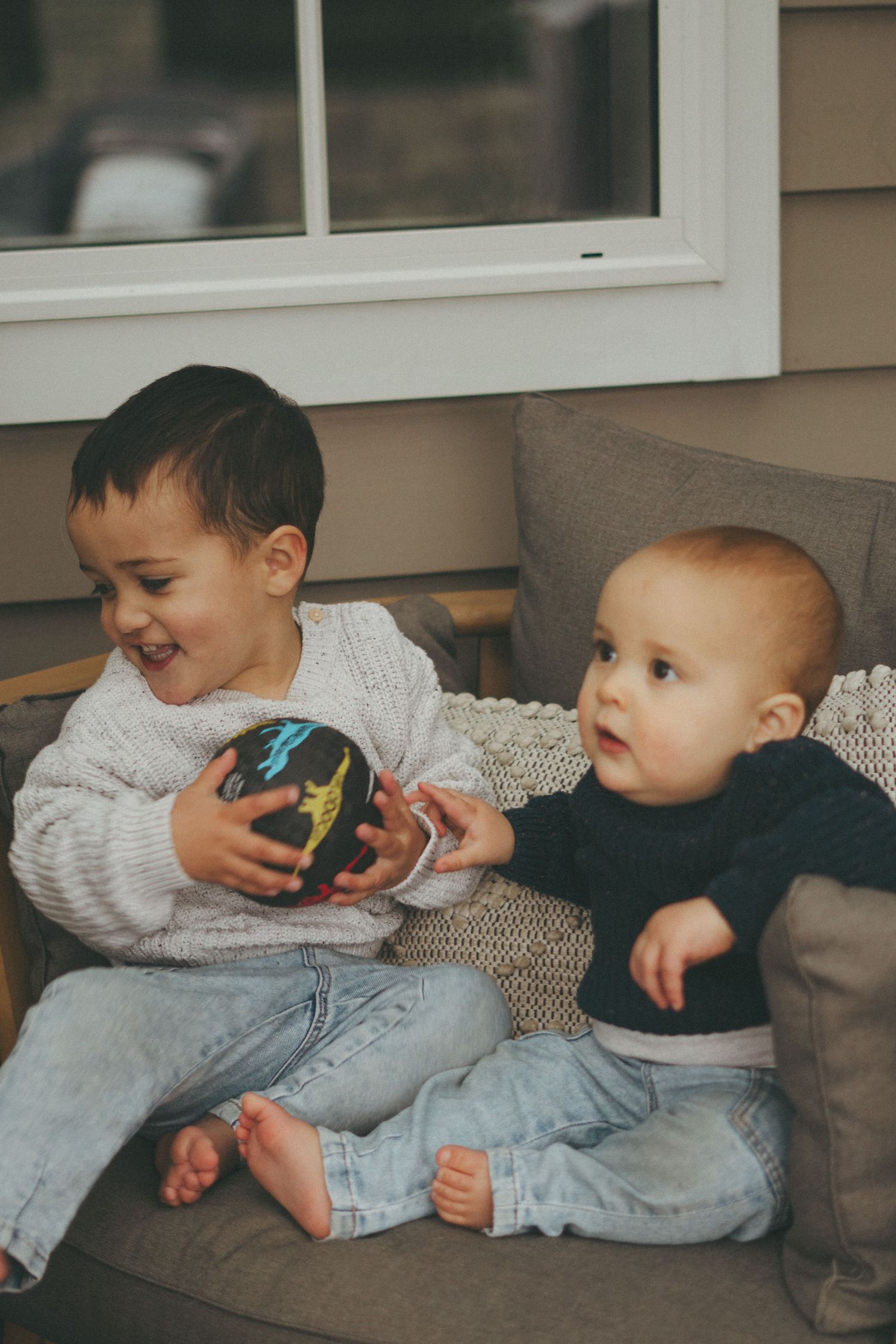 Series of candid shots showing young children playing on a couch.