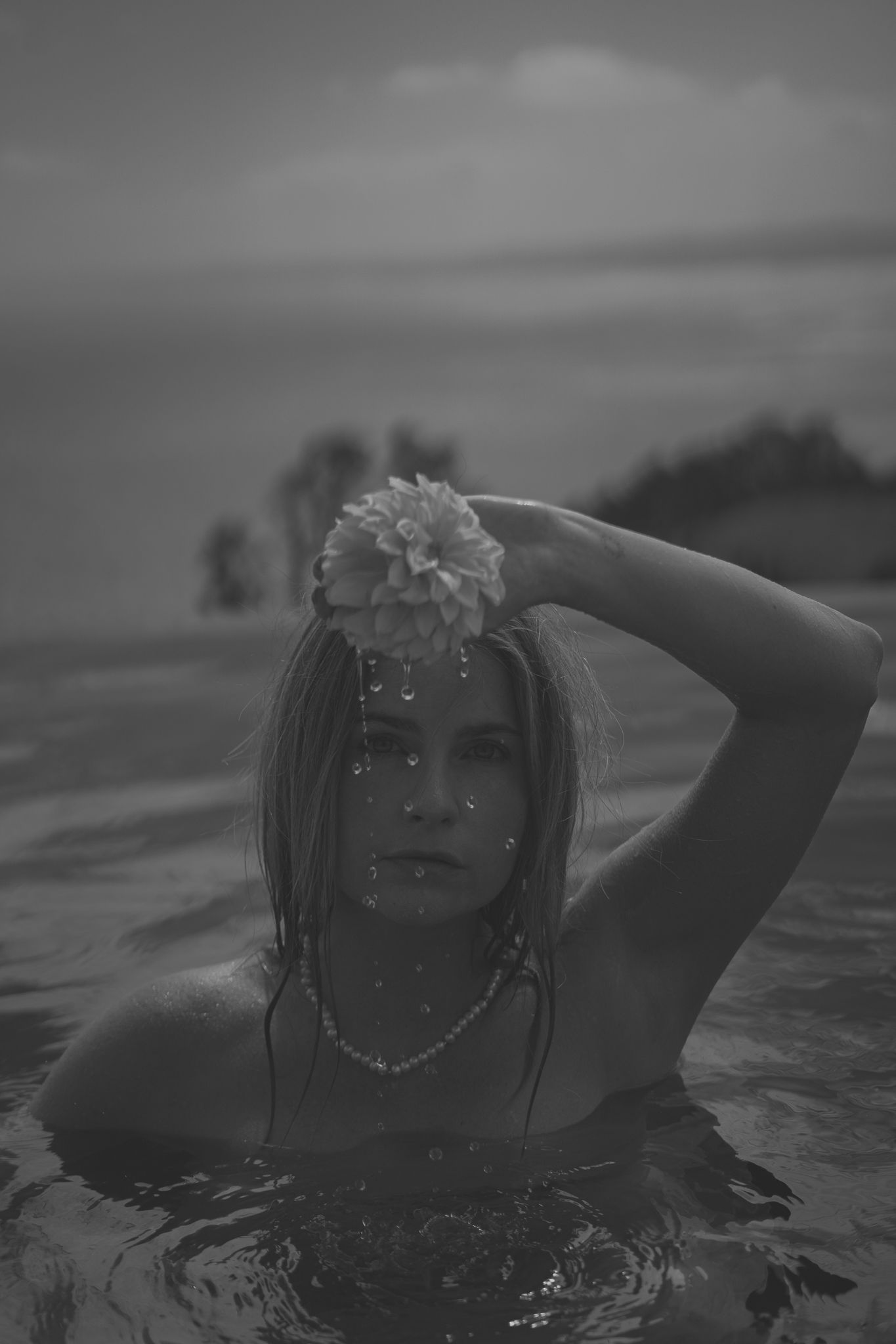Black and white artistic photo sequence of a figure emerging from dark water with dramatic lighting and water droplets.