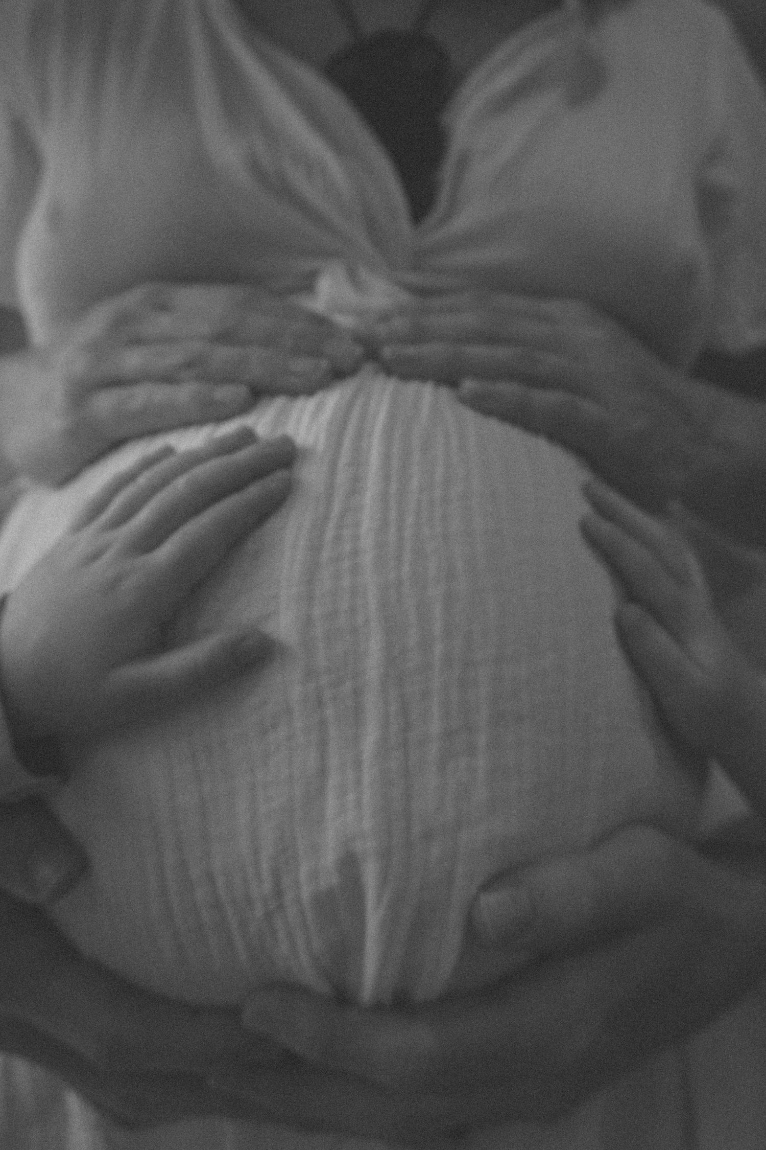 Black and white progression shots of a growing pregnant belly.