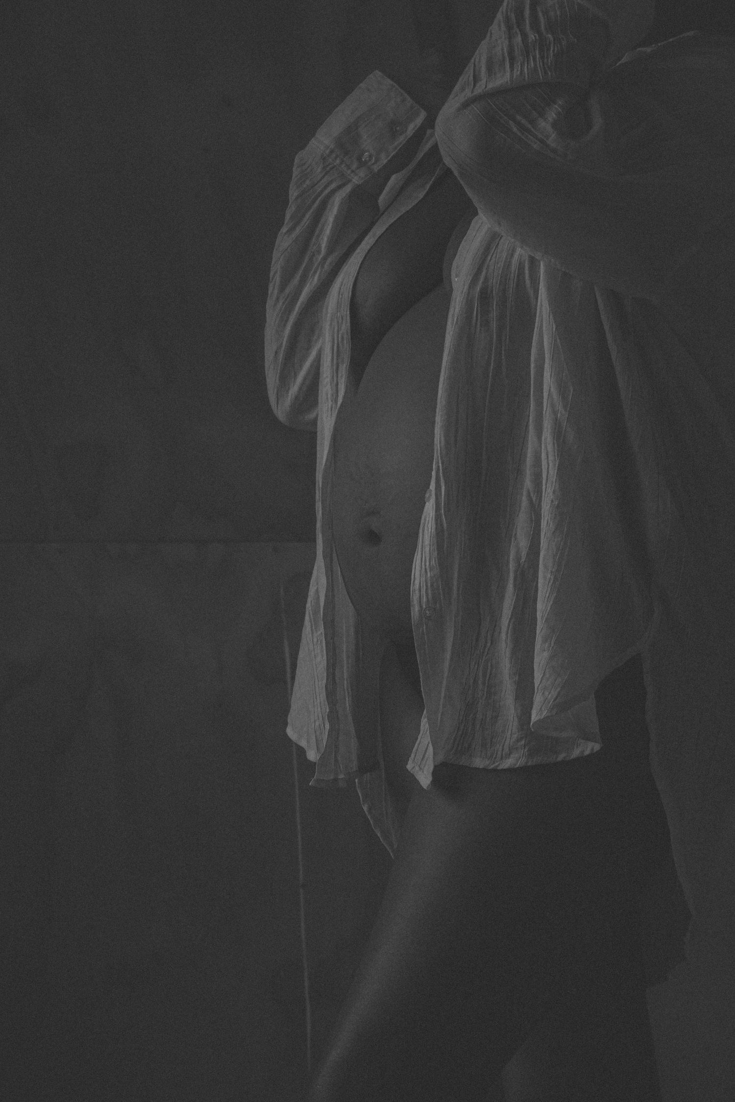 Dark silhouette series showing the profile of a maternity dress.