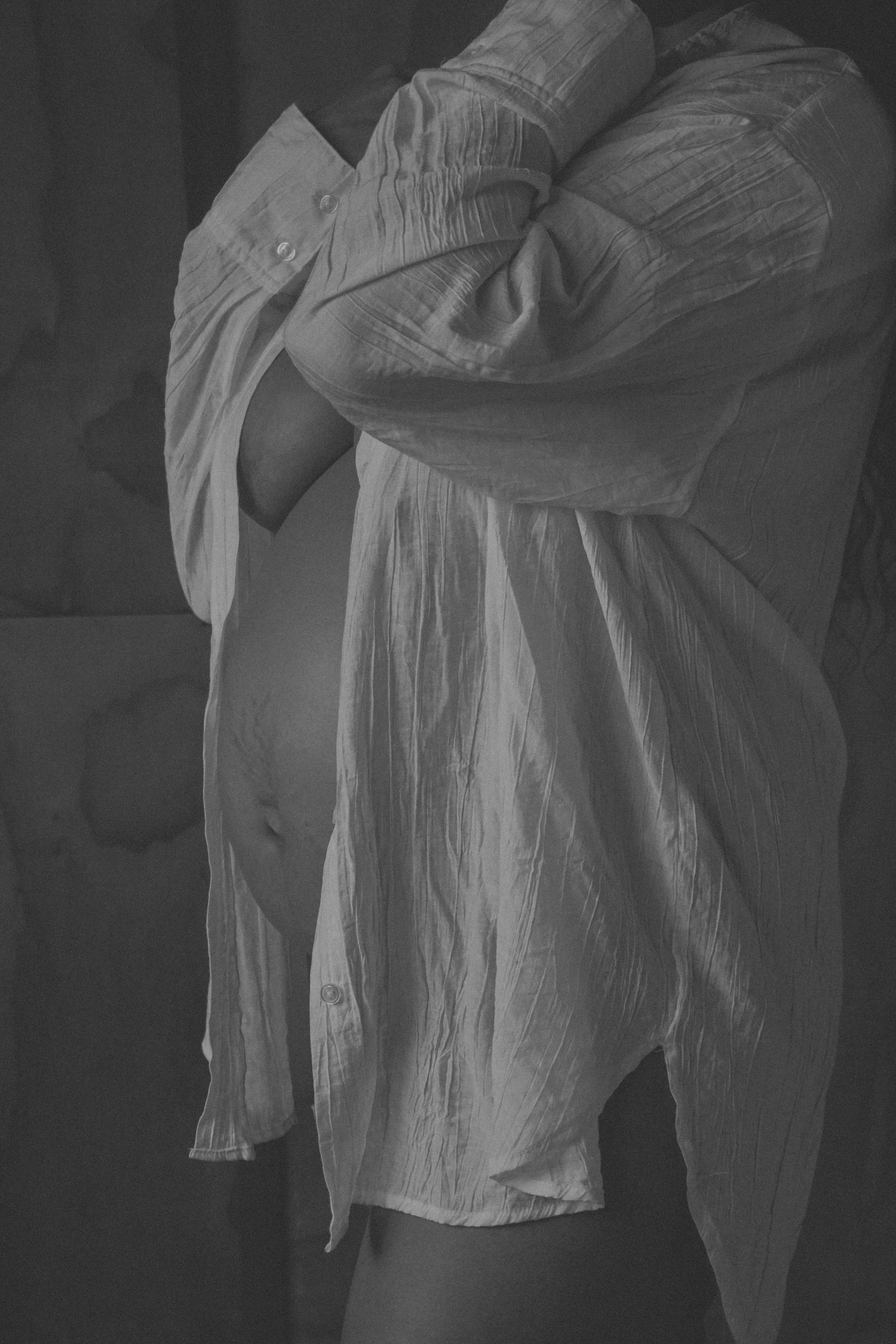 Black and white series showing flowing white dress movement against dark background.
