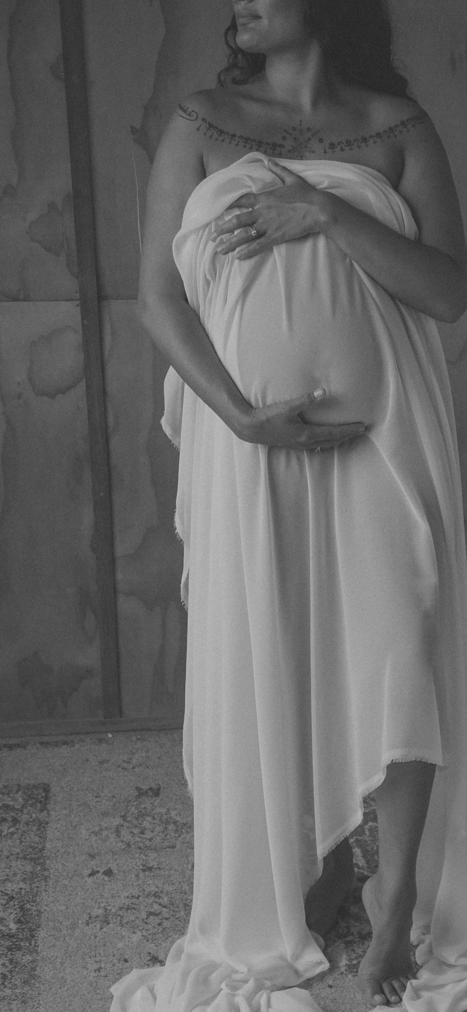 Elegant black and white portrait showing flowing white dress details.