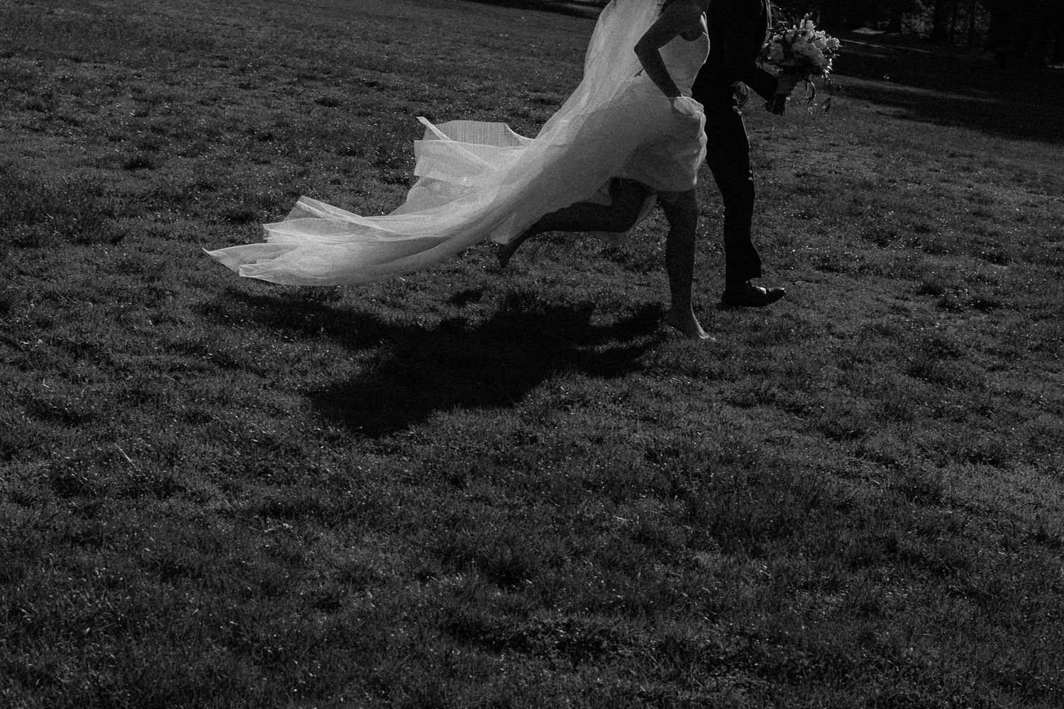 A series of black and white photos showing a person in a flowing white wedding dress running through a grassy field.