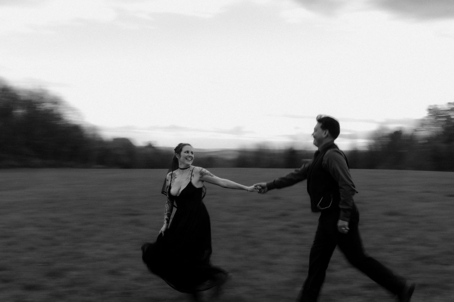 A black and white photo montage showing people walking and running across a scenic field at sunset.