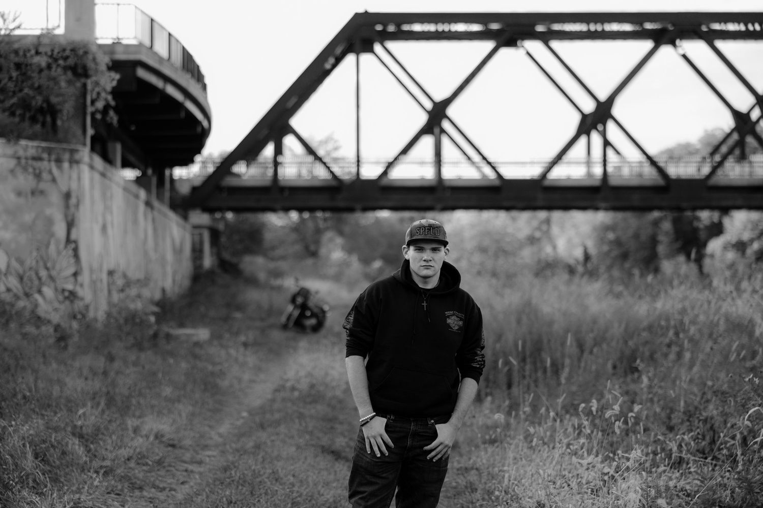 A black and white panoramic collage of railroad tracks and bridge structures in an industrial setting.