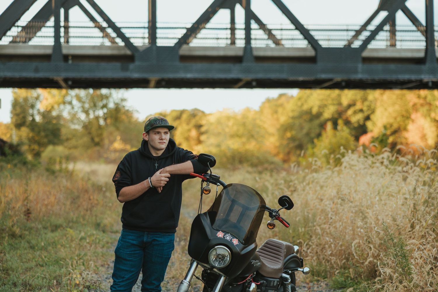 A series of motorcycle riders enjoying a scenic autumn ride through countryside roads and trails.