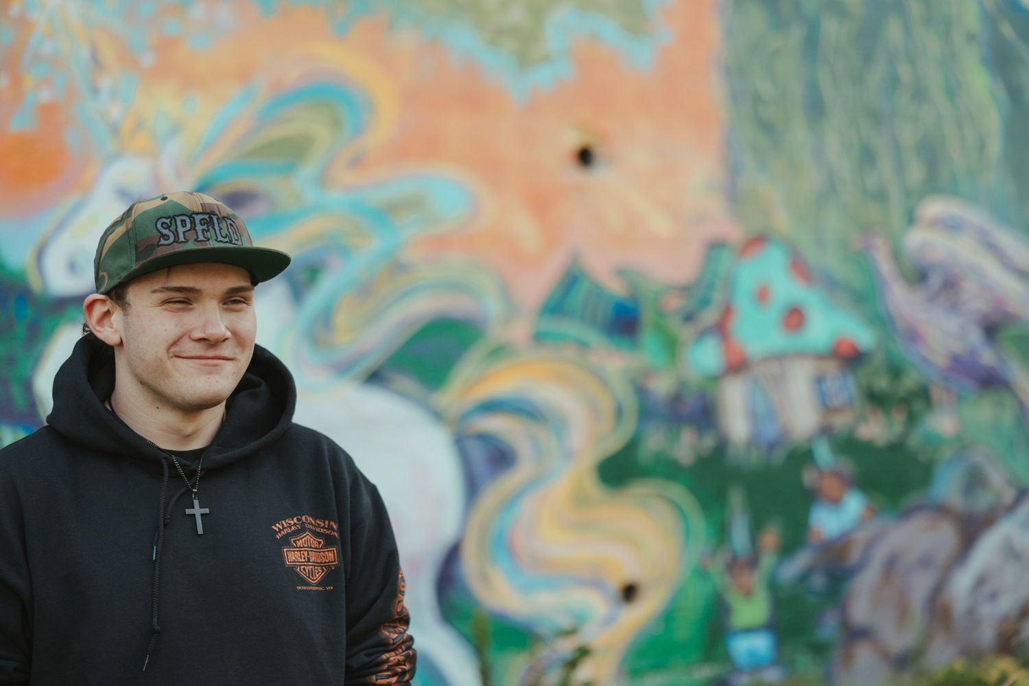 A series of five photos showing people in casual wear against colorful graffiti walls outdoors.