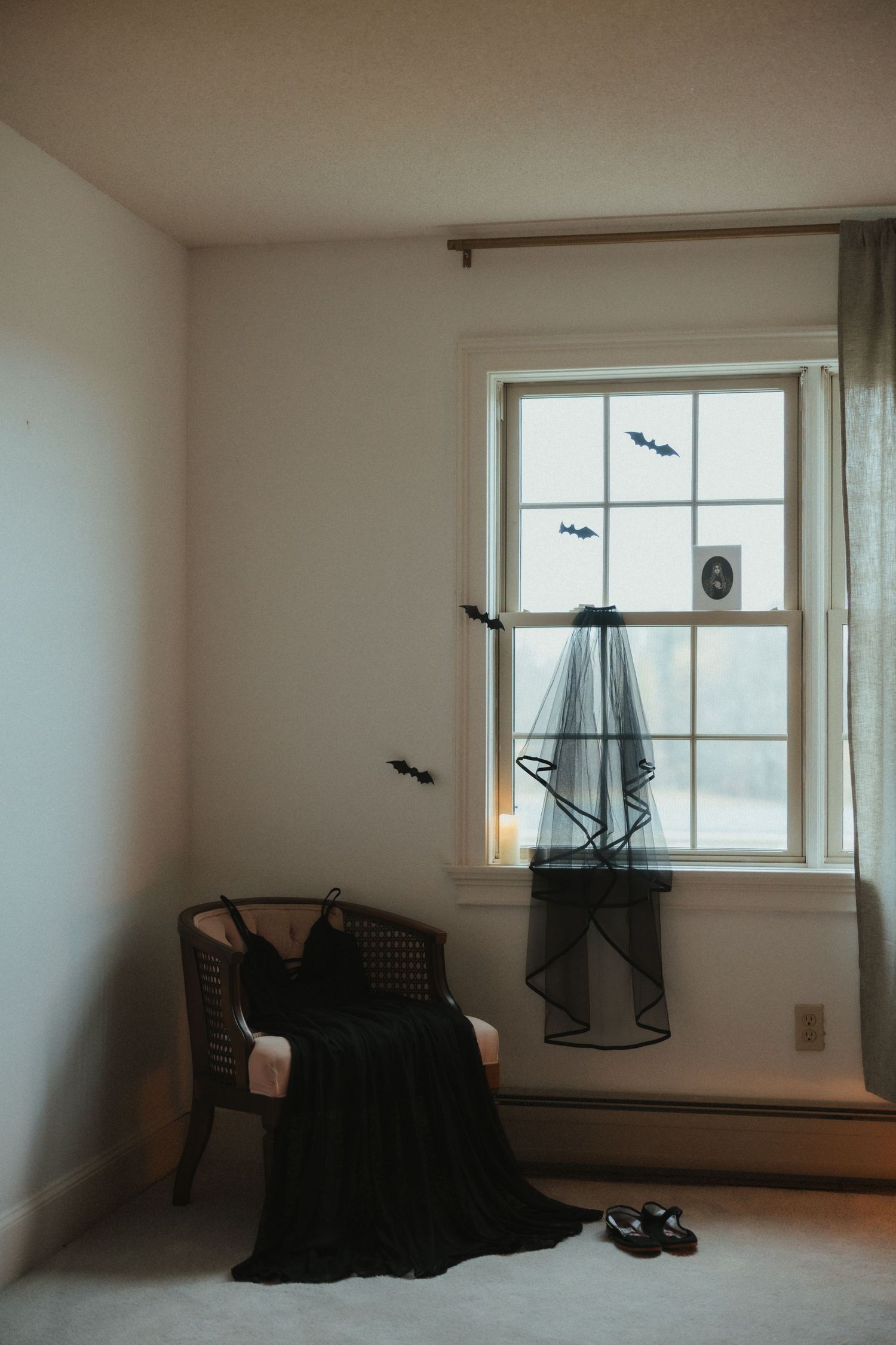 Artistic sequence showing black birds flying across a minimalist white room with a window.