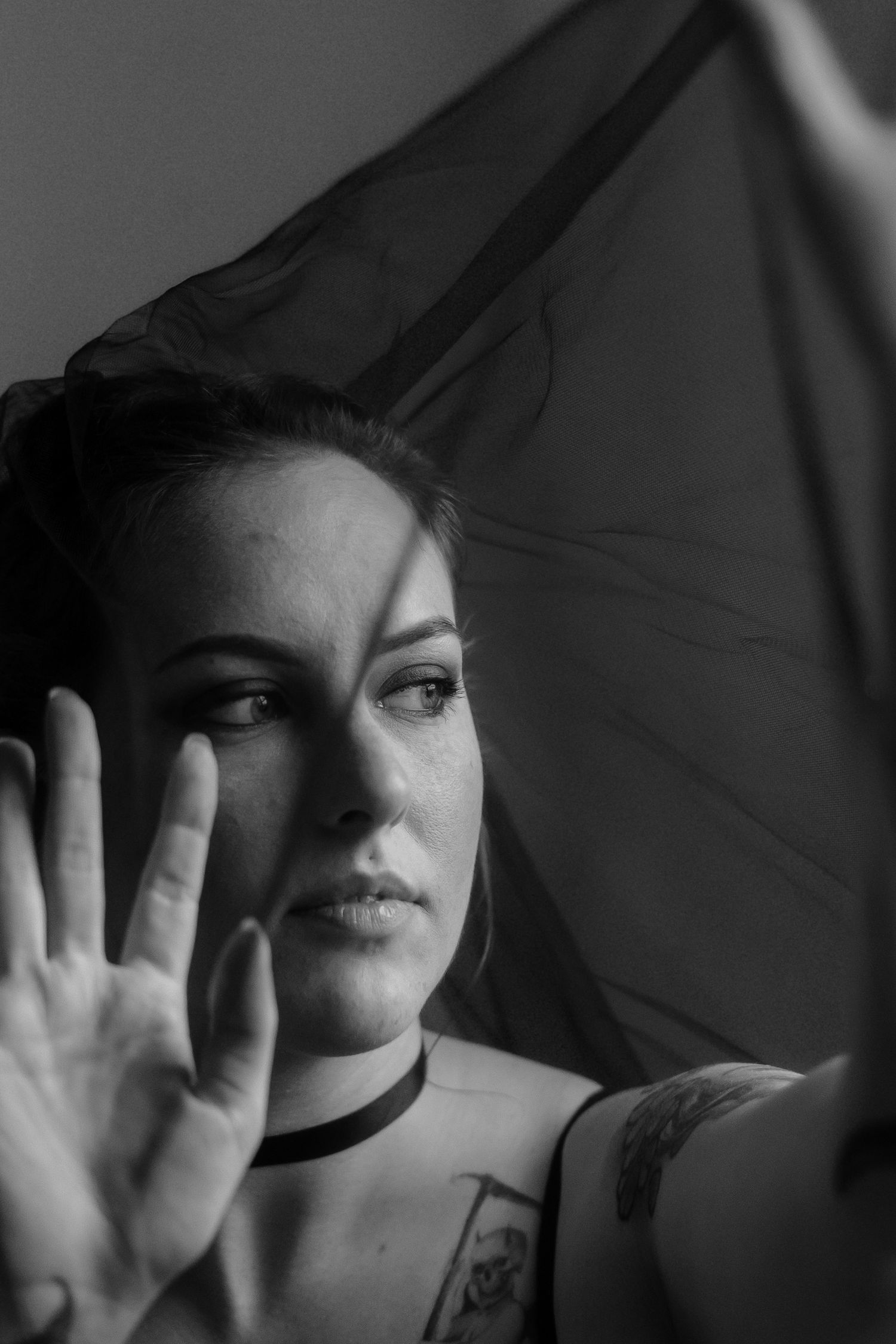 A dramatic black and white sequence shows a person's face partially obscured by hands in different poses against a dark background.