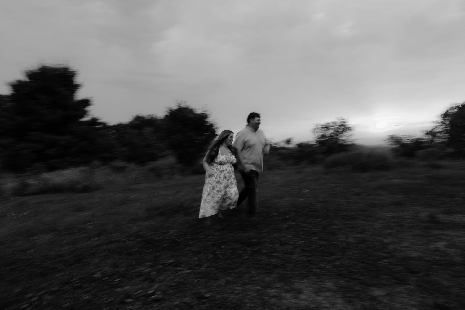 Black and white photography sequence showing people walking uphill through a dramatic misty landscape.