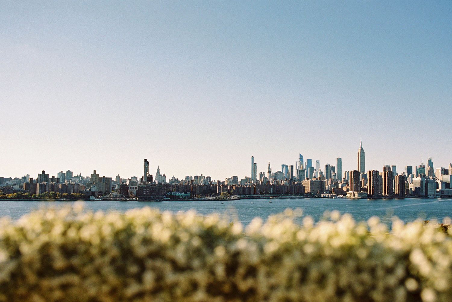 New York skyline from Wythe Hotel rooftop in Williamsburg, Brooklyn; editorial film wedding photographer