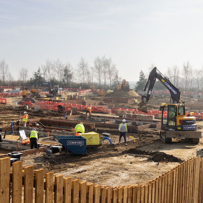 Site documentation of residential construction foundations and heavy machinery by AHP Photo.