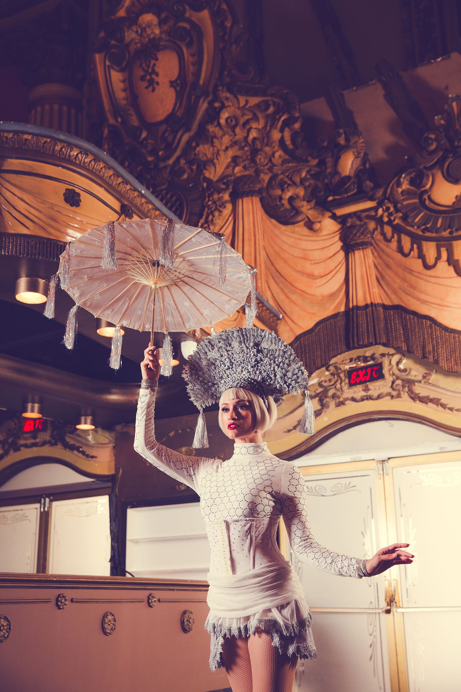 How can I increase revenue with a Los Angeles Brand Photography session? Performer in a costume holds a parasol in an ornate vintage theater