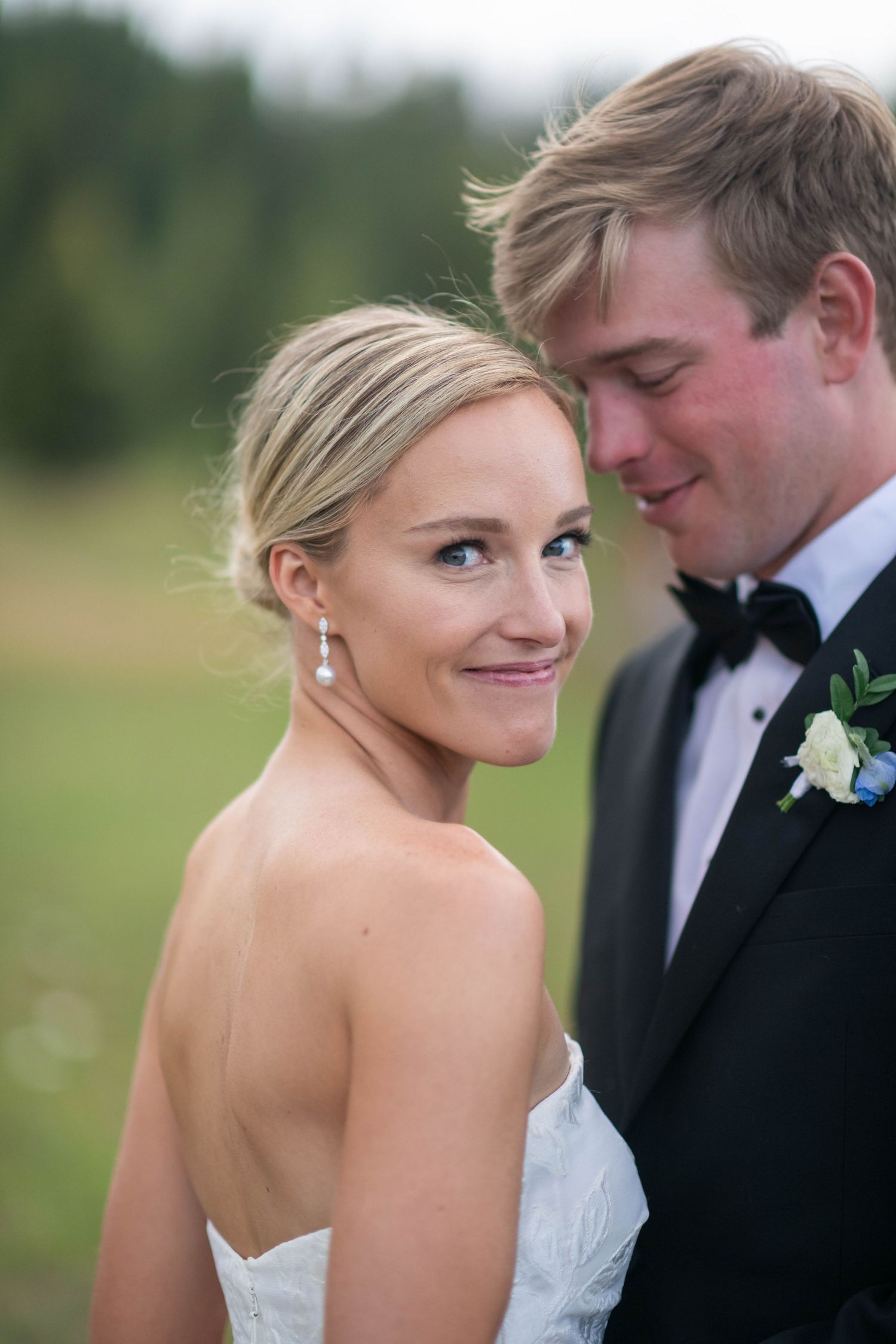 Intimate wedding couple moment captured in an outdoor setting.