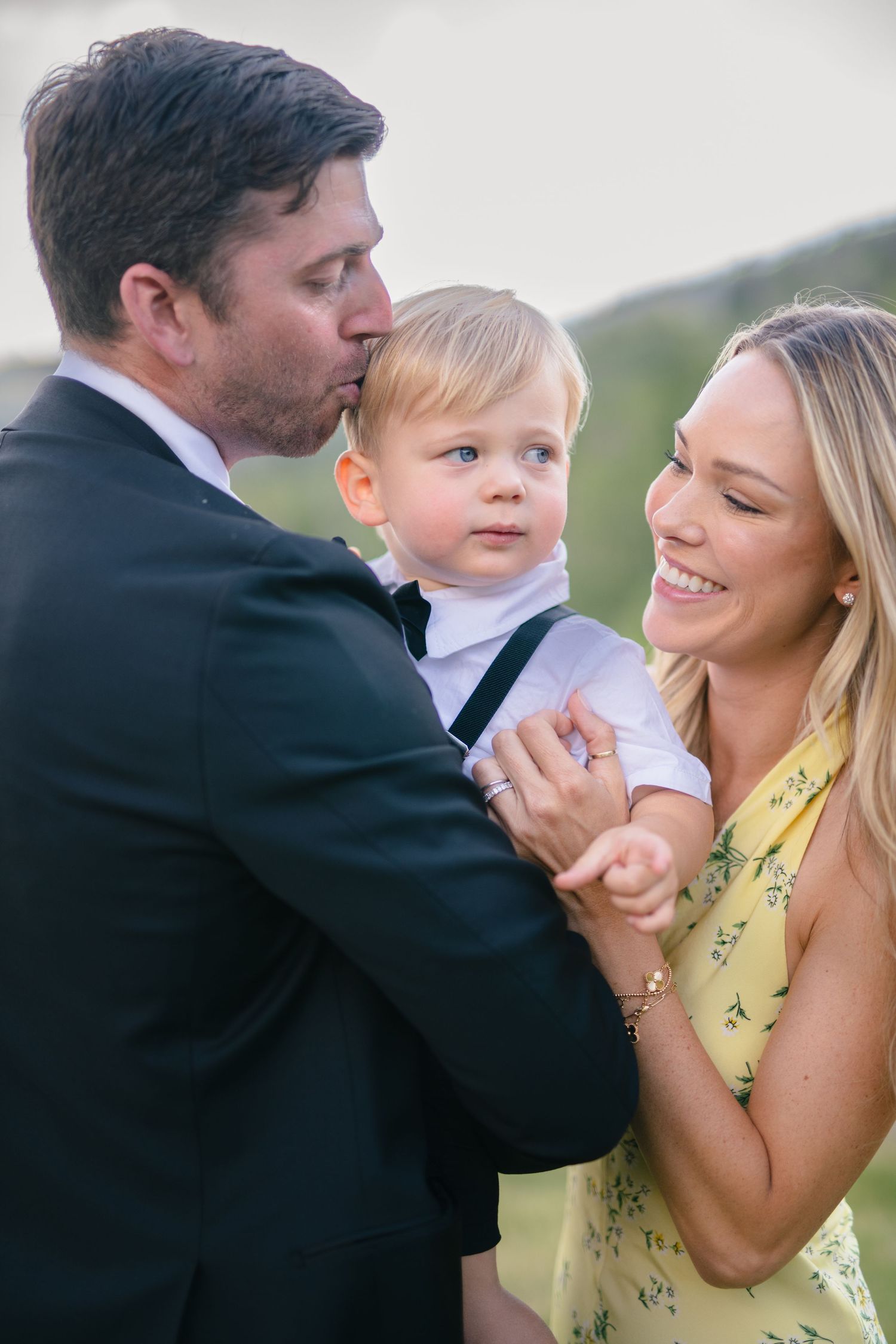 A family shares playful candid moments together in a series of outdoor portraits.