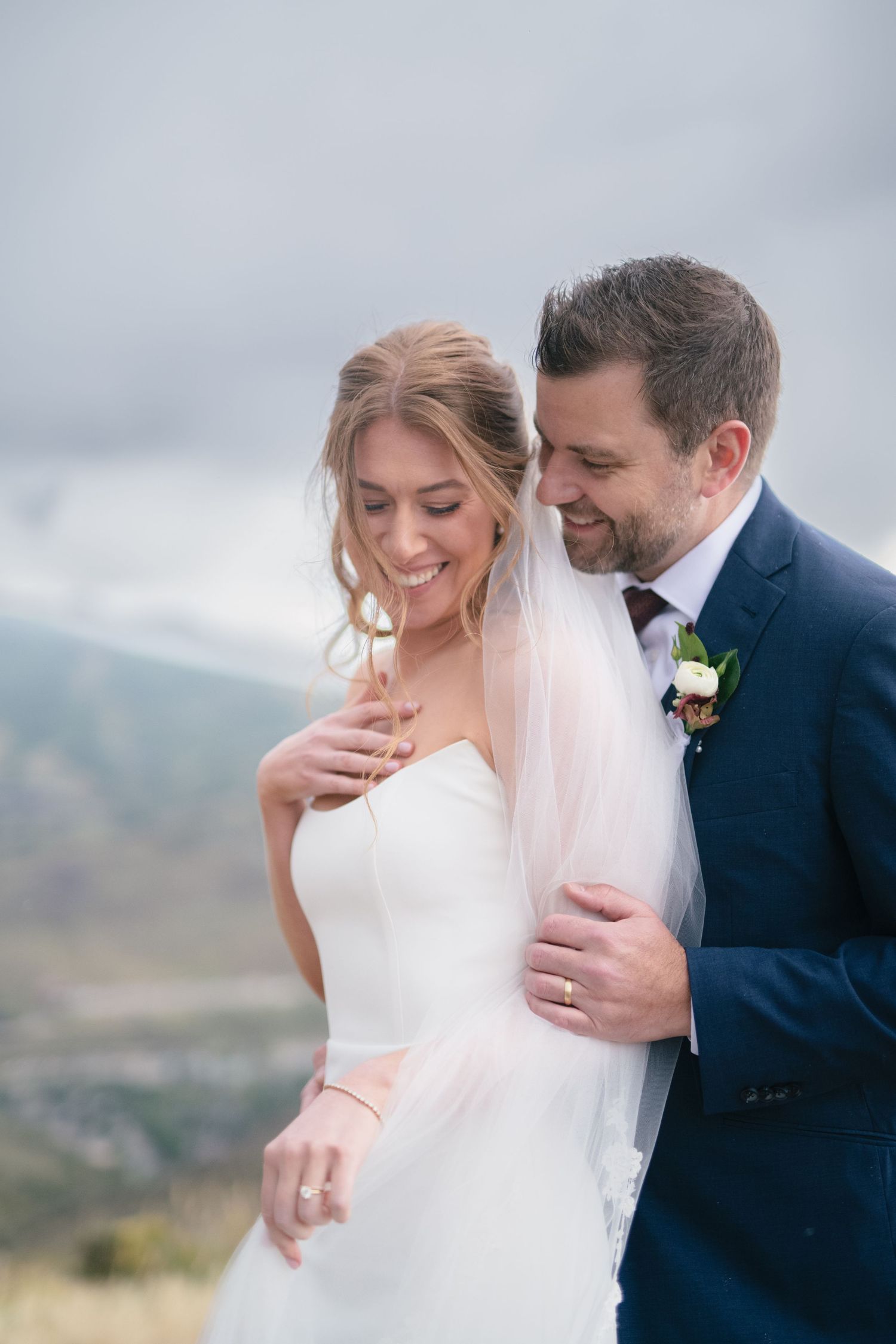 A romantic wedding photoshoot sequence showing tender moments between a couple against a mountain backdrop.