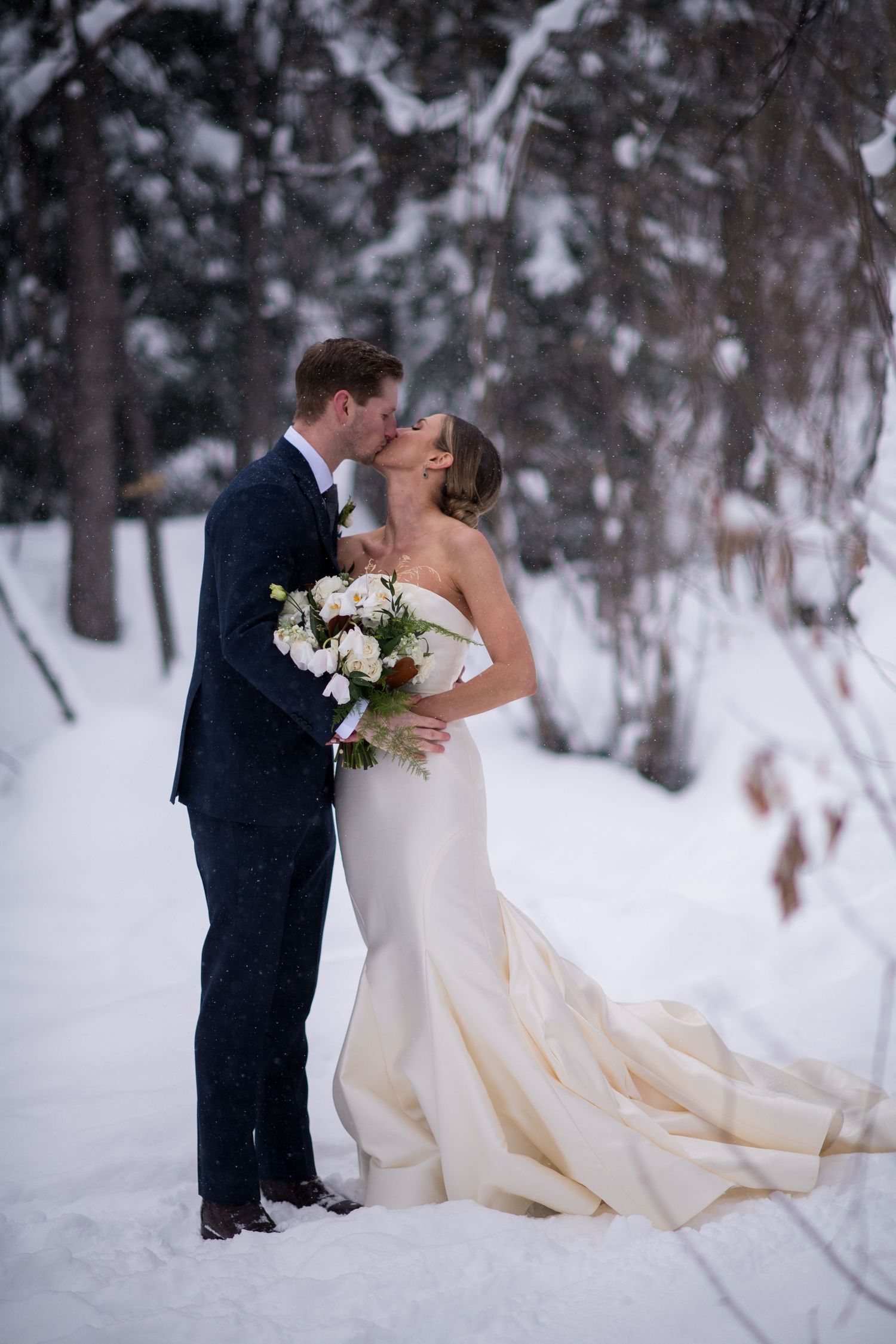A romantic winter wedding photoshoot in a snowy forest setting in Beaver Creek.