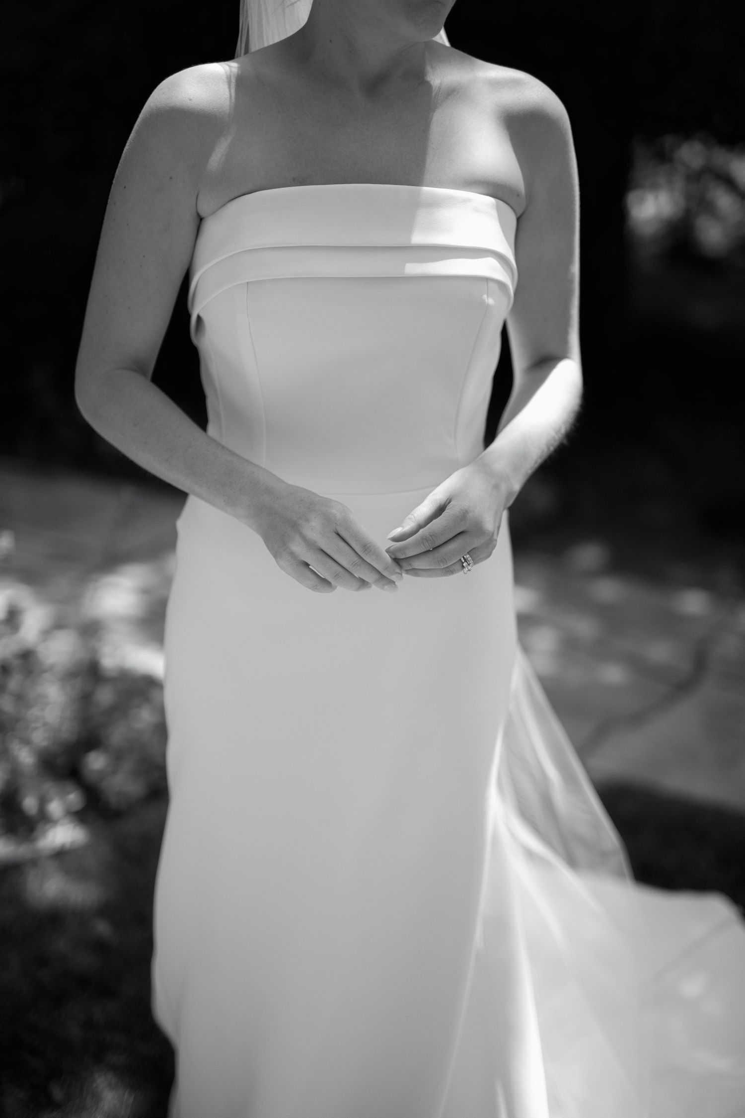 Close-up detail of a minimalist strapless wedding gown in black and white.