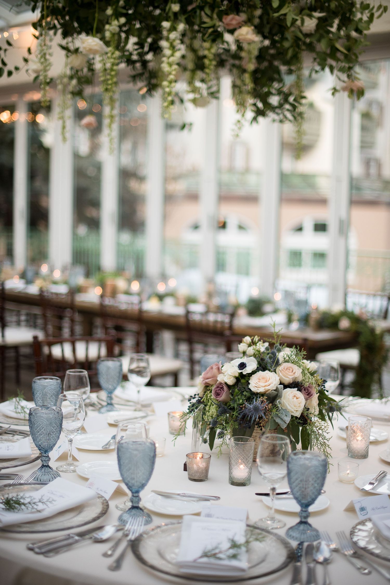 Elegant wedding reception table with blue glassware and floral centerpieces at Sonnenalp Vail.