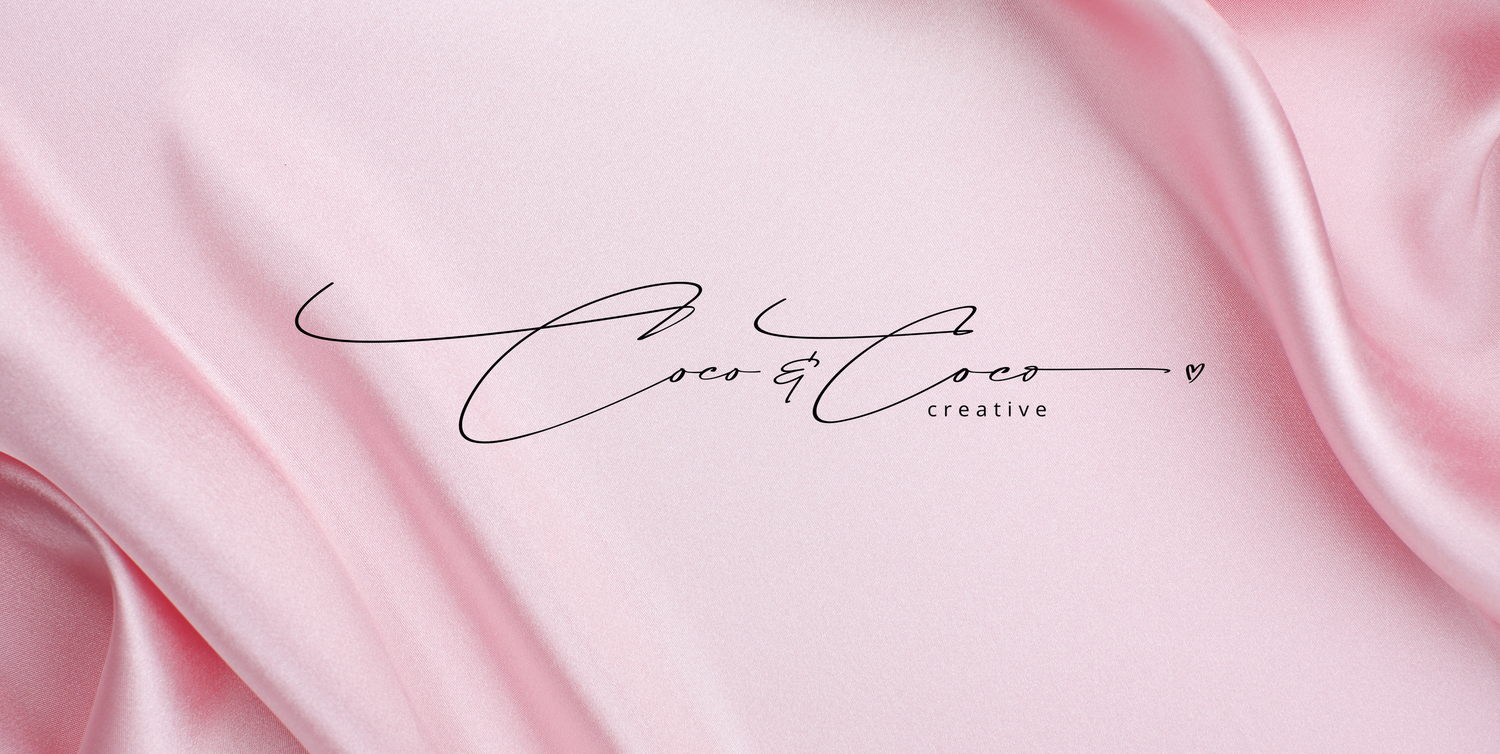 Smooth pink satin textile background with black signature text.