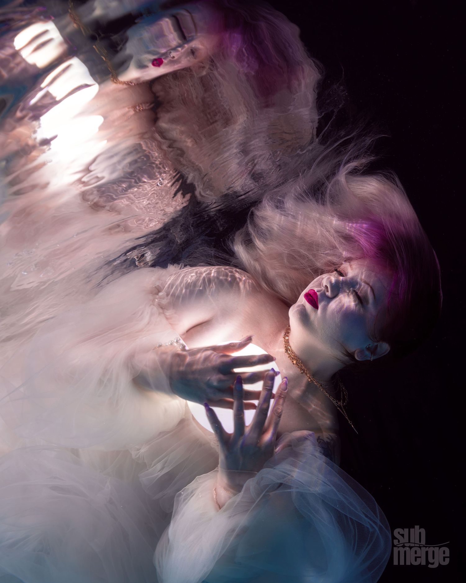 Abstract motion blur photography creates ethereal effect with swirling white and purple colors against dark background.