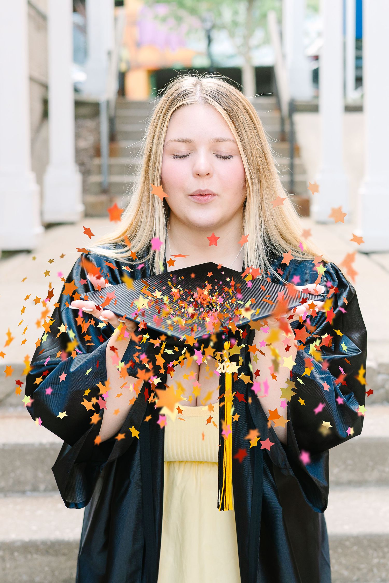 Graduation celebration sequence showing colorful confetti being thrown and scattered in the air while wearing black gown.