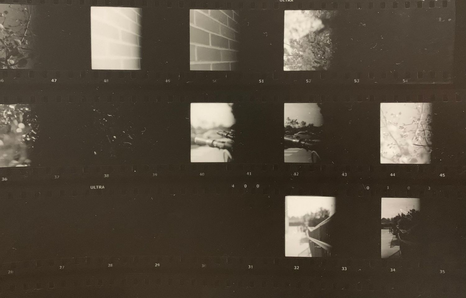 The image shows a collage of several abstract, textured black and white photographic images.