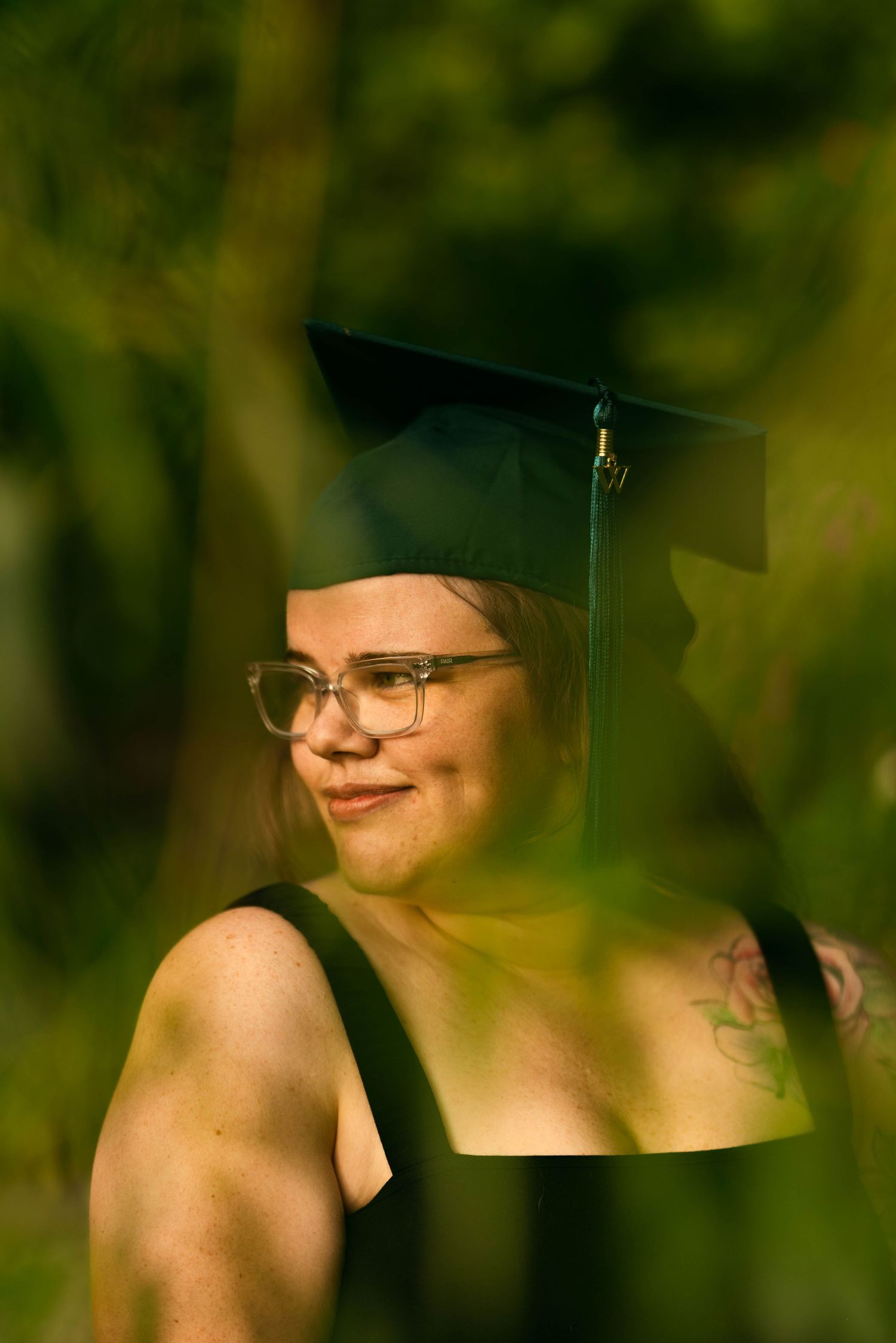 Graduation cap and warm lighting create artistic portrait series.