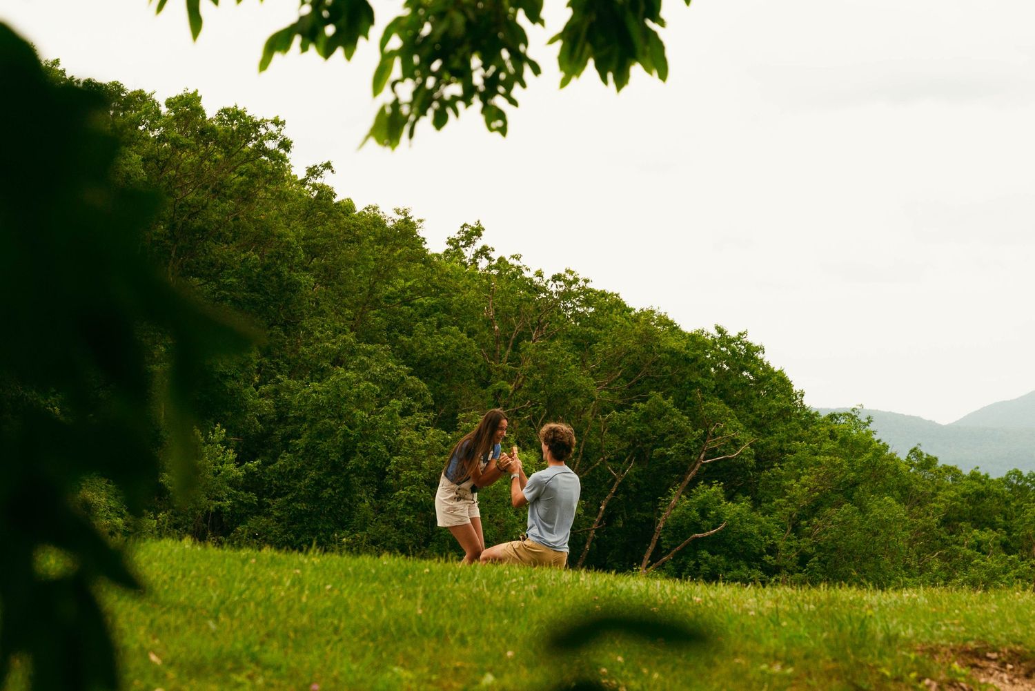 Rolling green hills and mountains create a peaceful natural landscape.