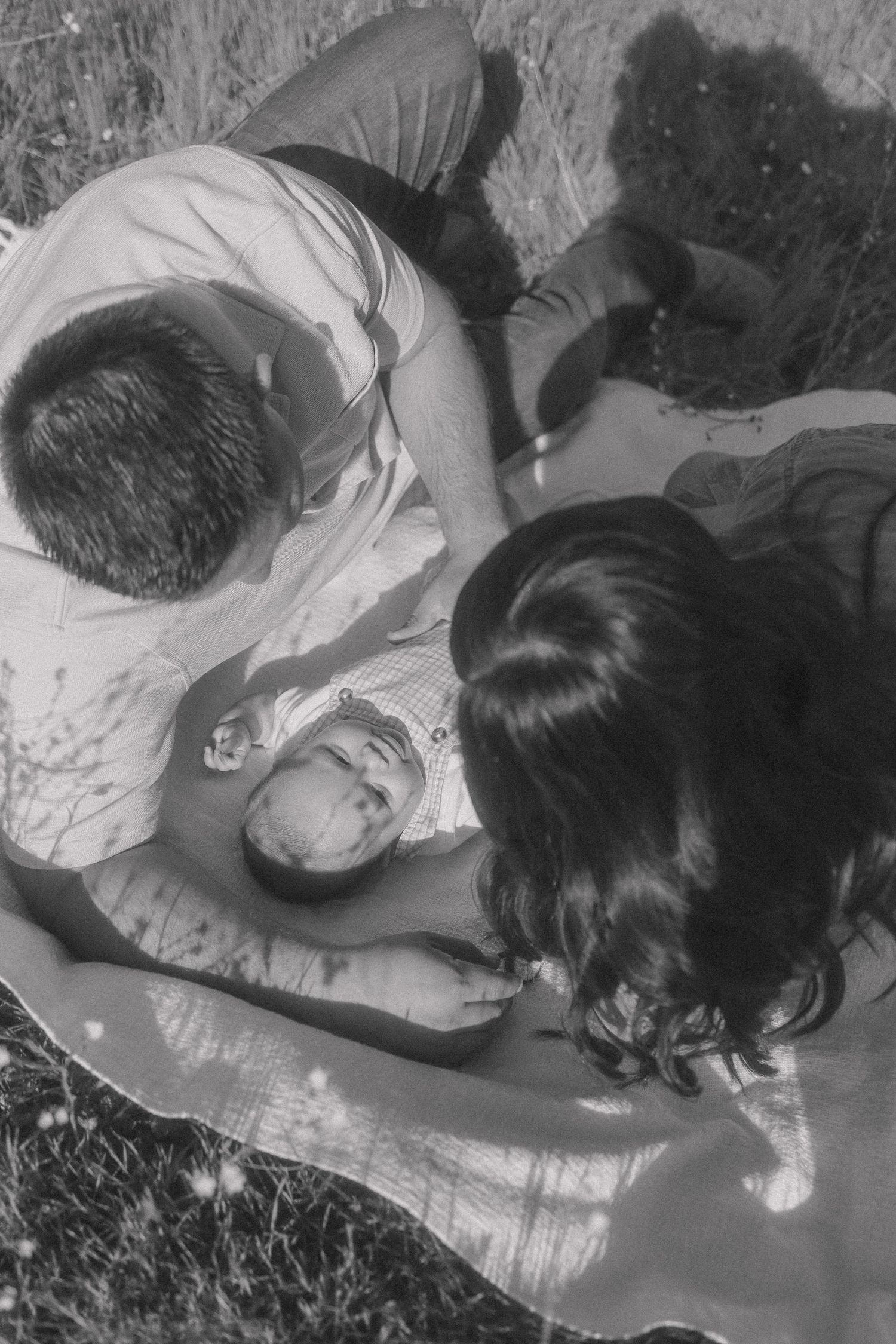 A series of black and white photographs showing people sleeping on white bedding.