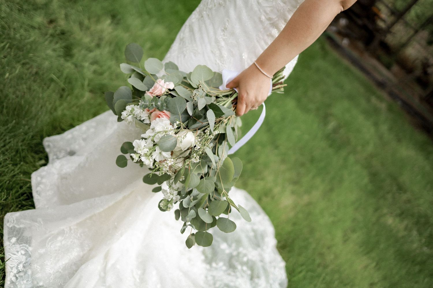 Close-up shots of a bridal bouquet with white flowers and green eucalyptus leaves.