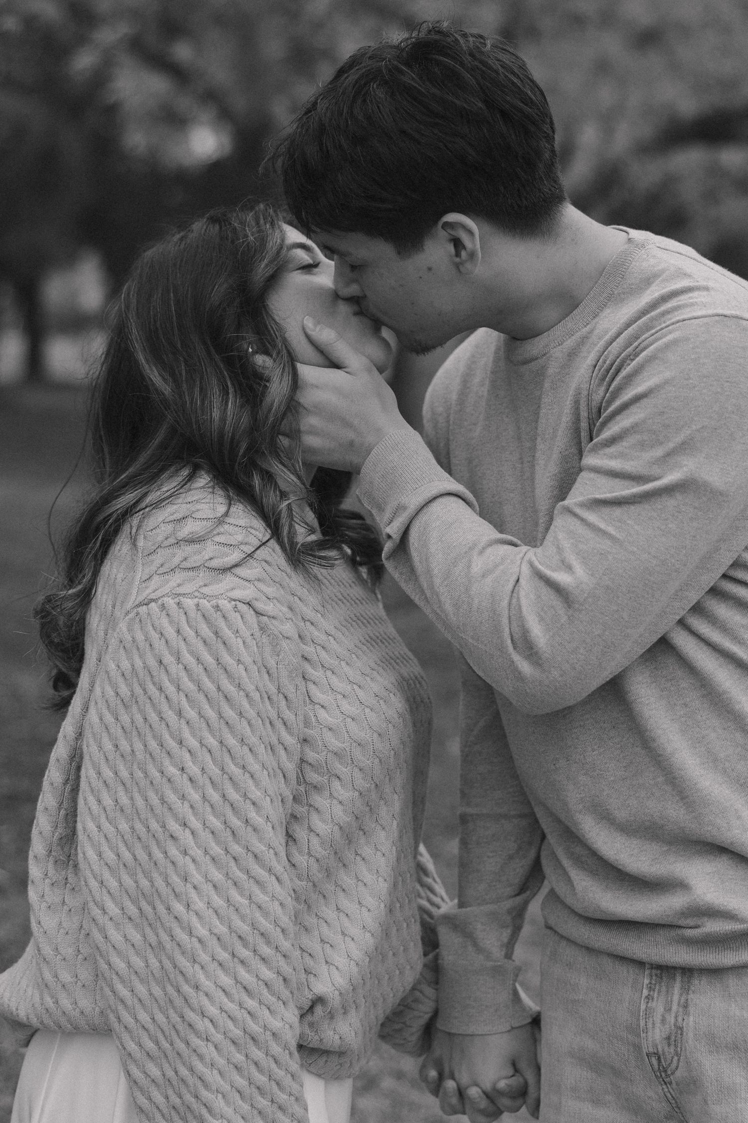 An intimate romantic moment shared between a couple in cozy sweaters.