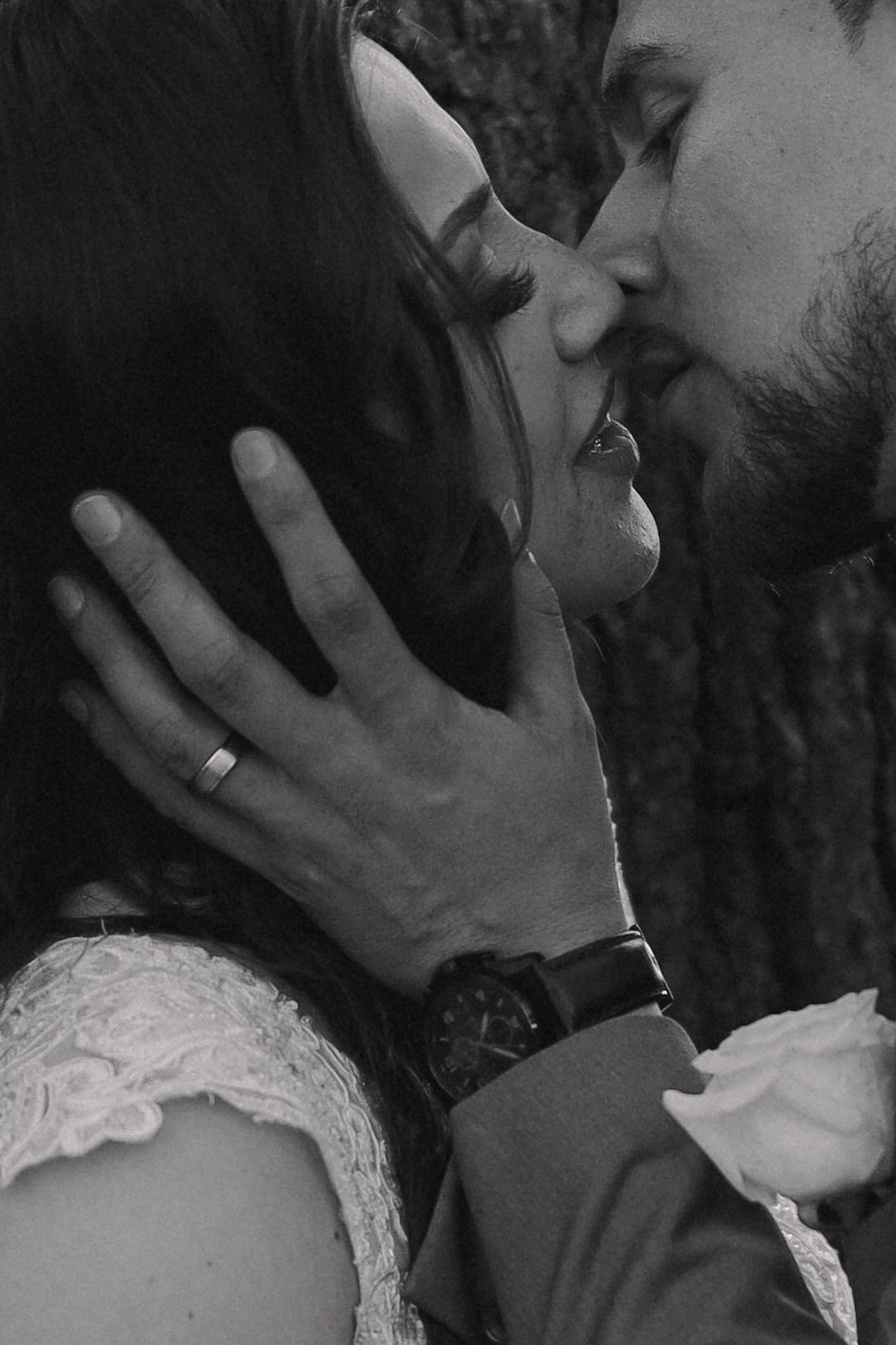 A romantic black and white photo series showing intimate moments between a couple embracing and kissing.