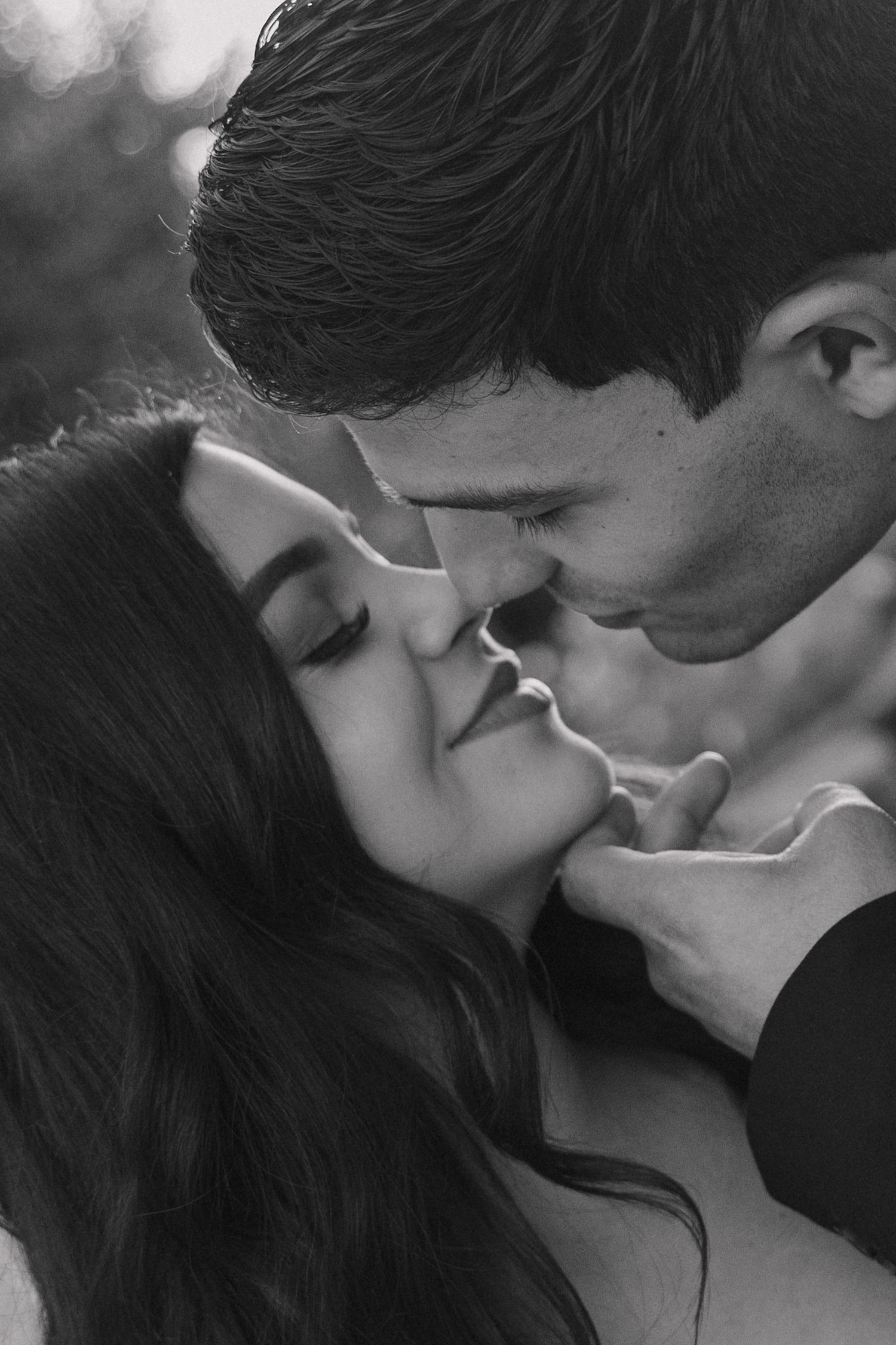 Black and white romantic sequence of a couple sharing an intimate moment.