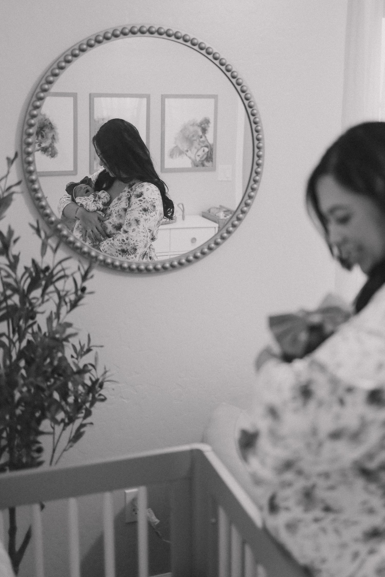 A series of intimate black and white photos showing tender moments in a nursery setting.