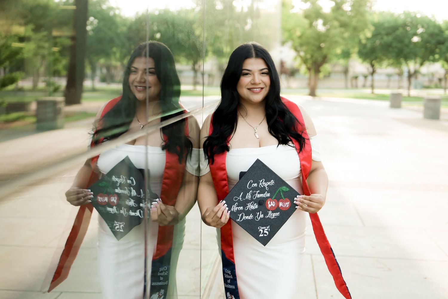 Two people in coordinating outfits hold chalkboard signs while walking and smiling in an outdoor setting.
