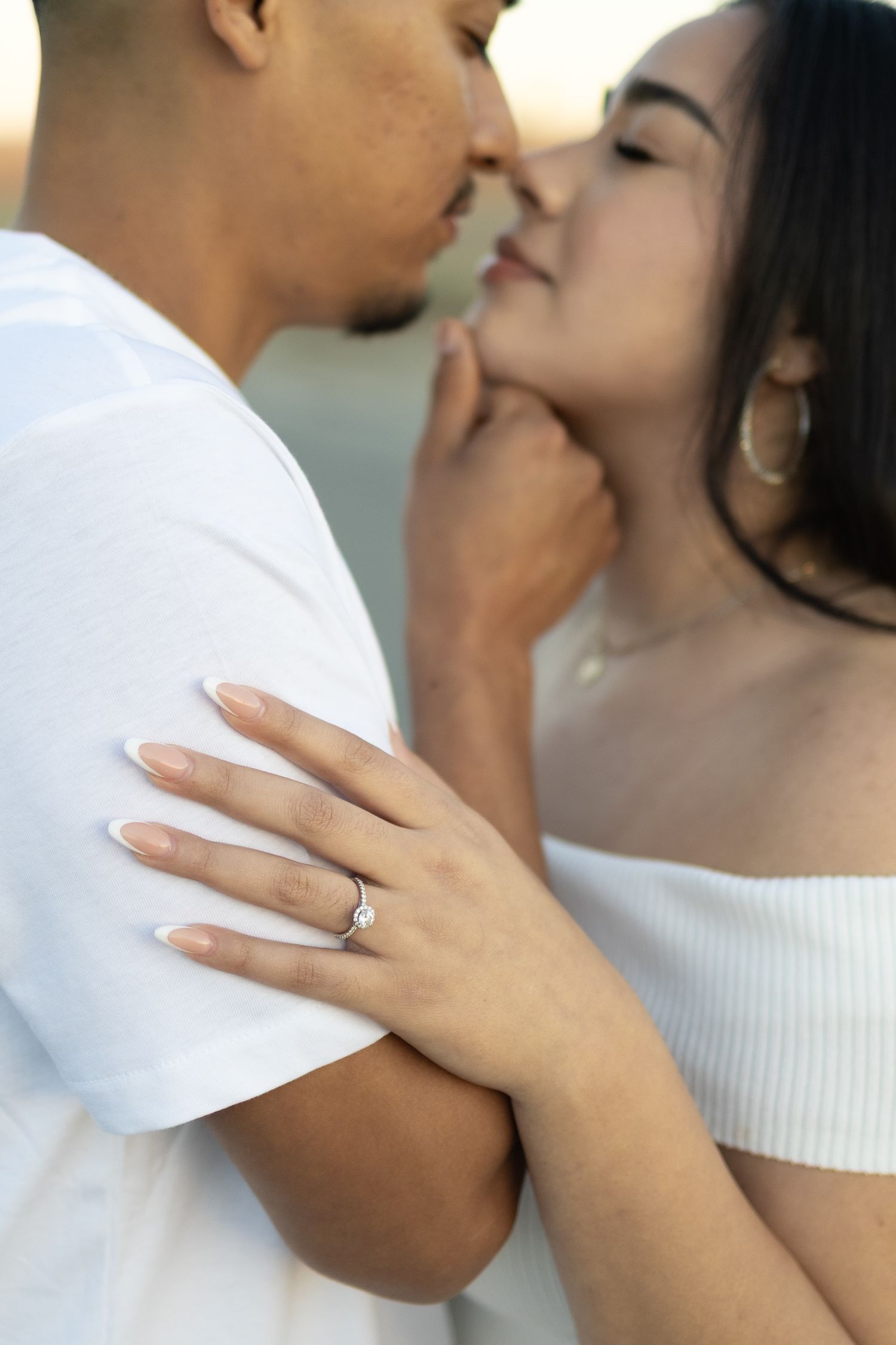Close-up shot showing hands and rings during an intimate embrace.