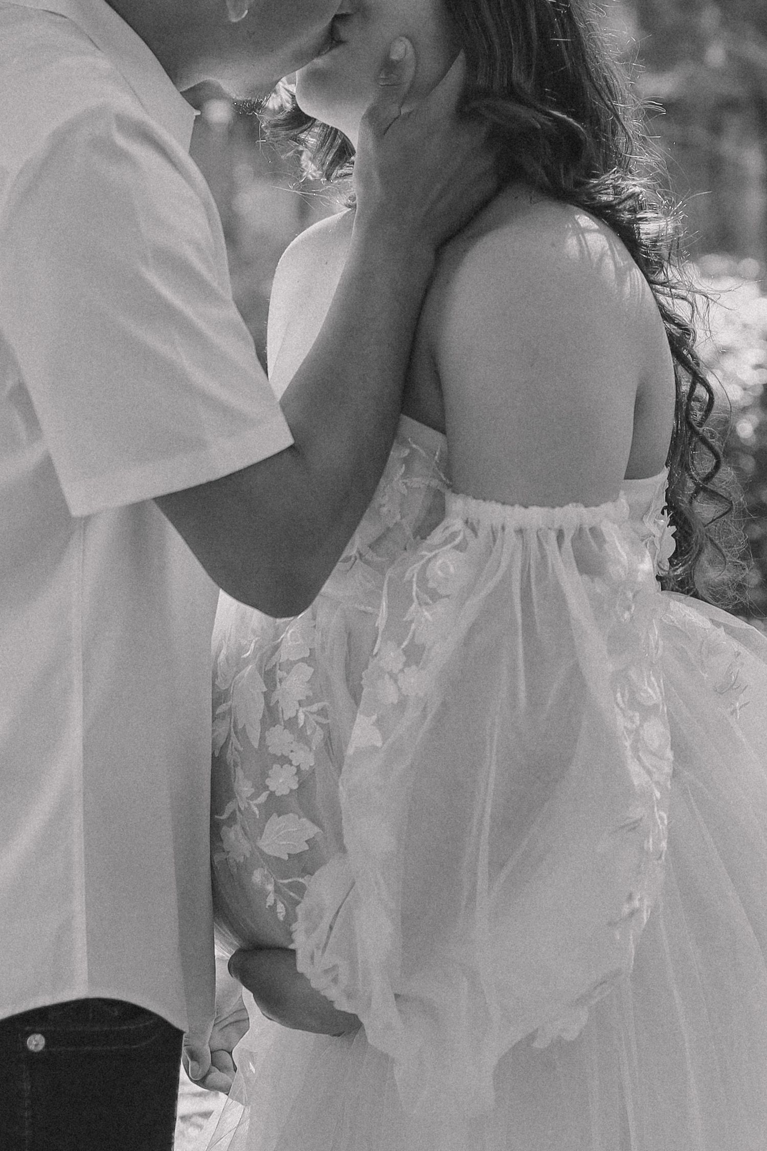 A romantic black and white wedding photo series showing tender moments between a bride and groom.
