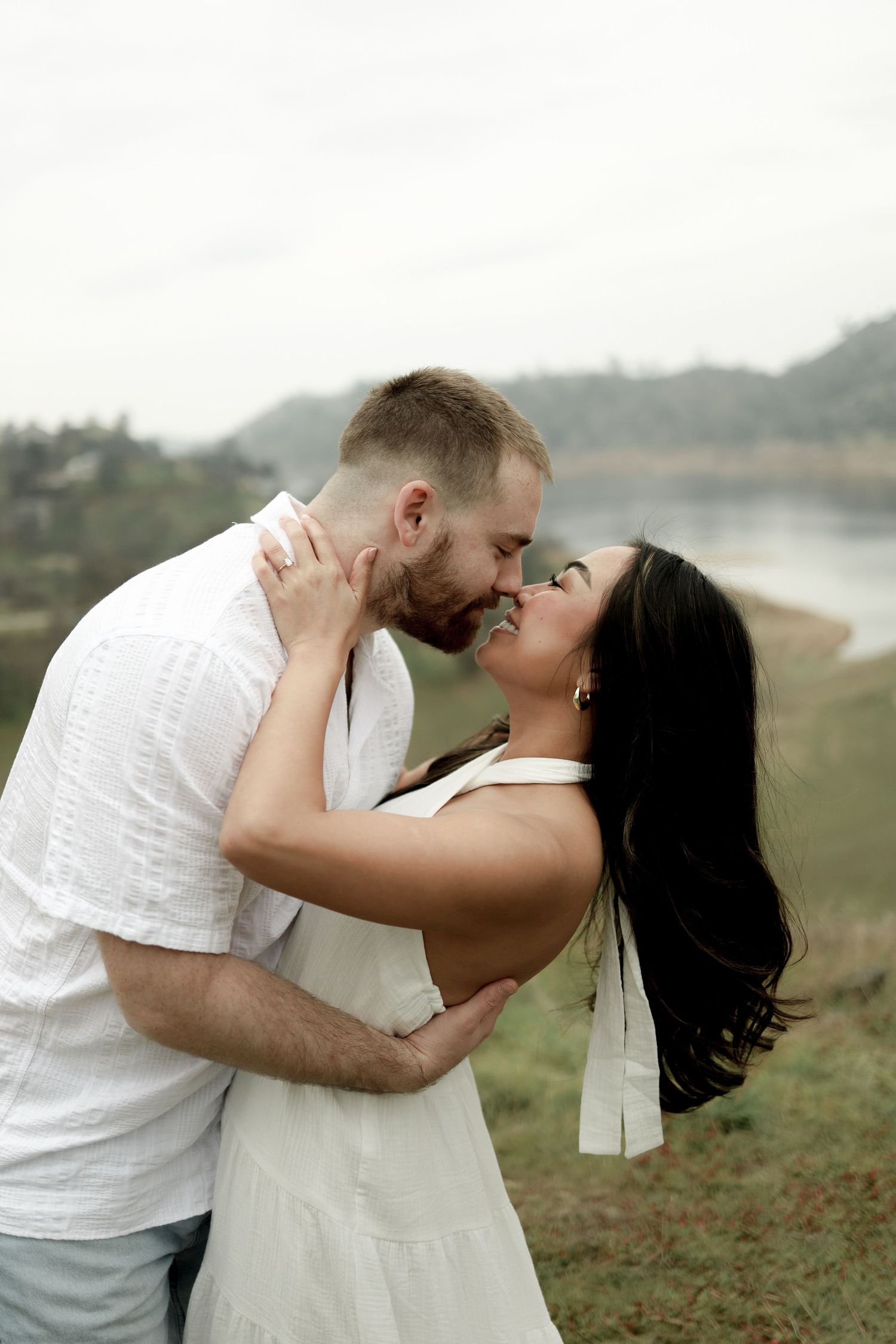 Romantic outdoor portrait sequence against a misty natural backdrop.