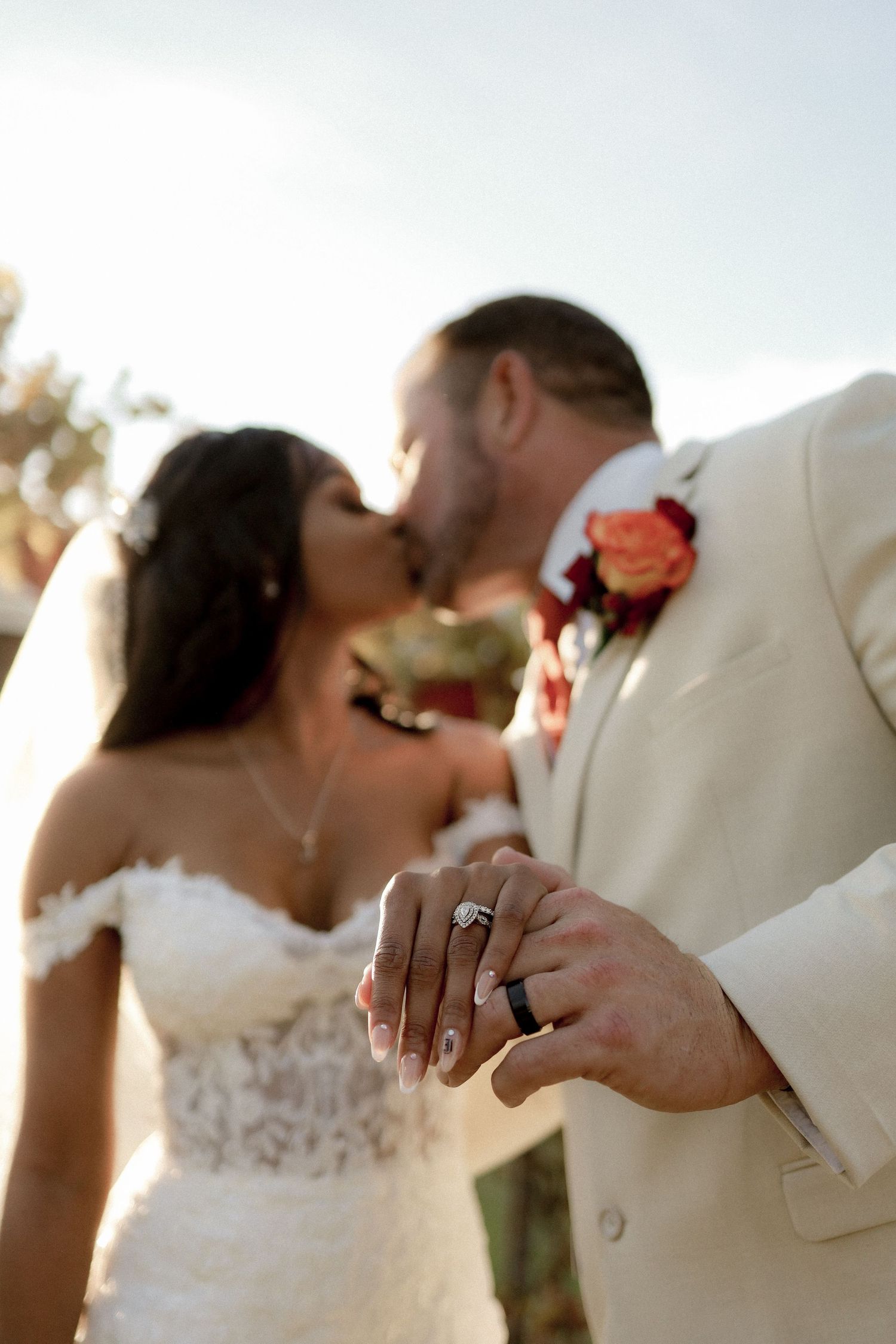 Close-up shots of wedding couple's hands and rings during romantic sunset moment.