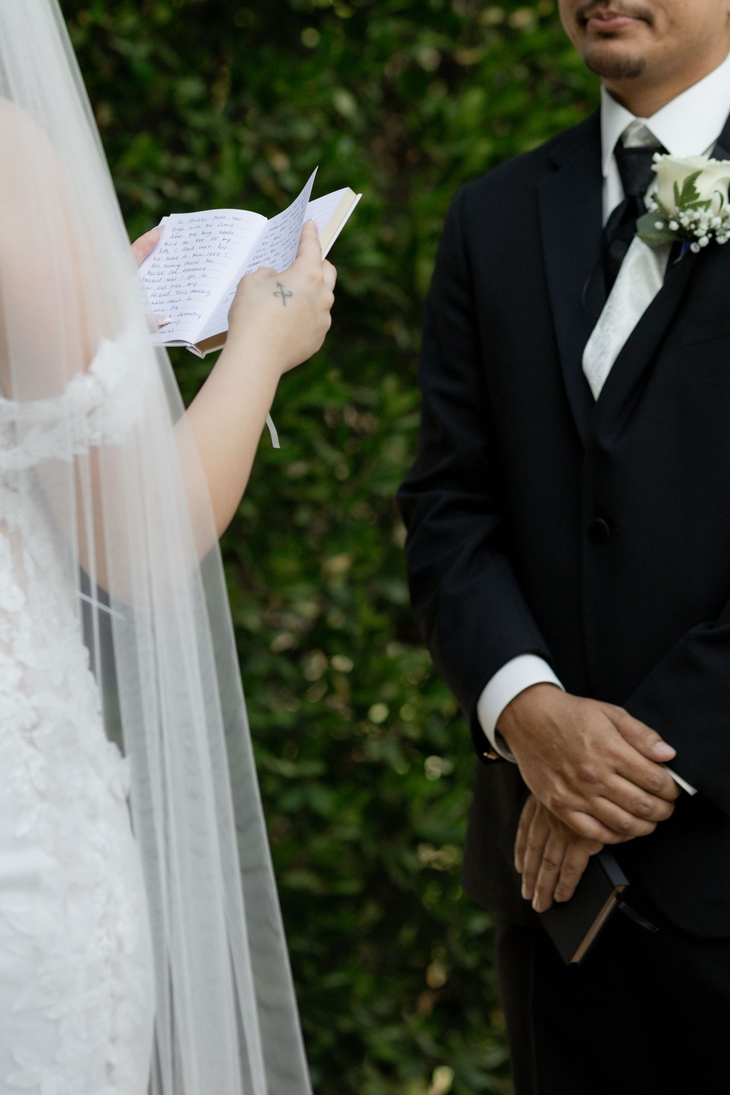 Close-up details of a wedding ceremony with white veil and formal attire.
