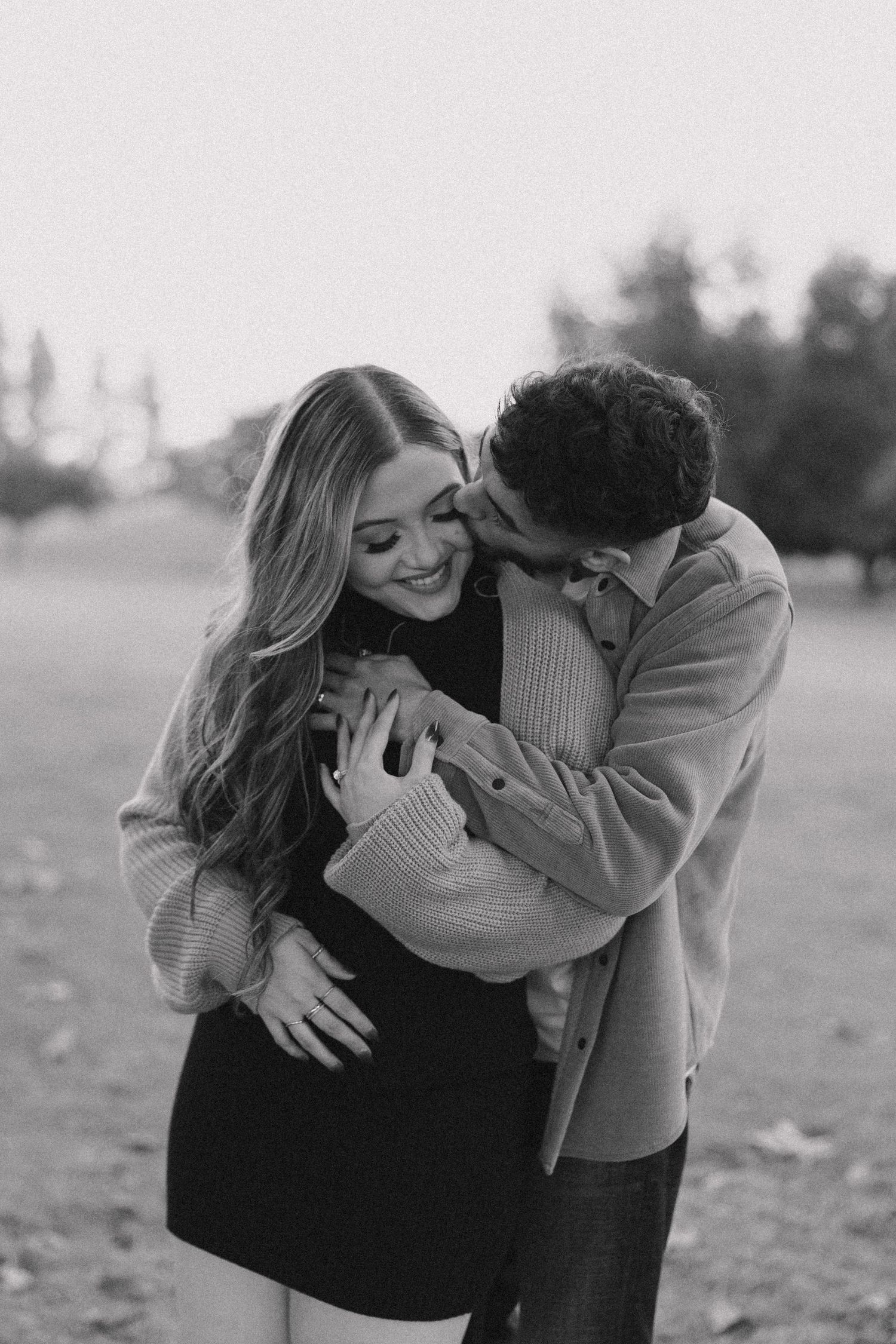 A tender black and white photo sequence showing an intimate embrace in an outdoor setting.