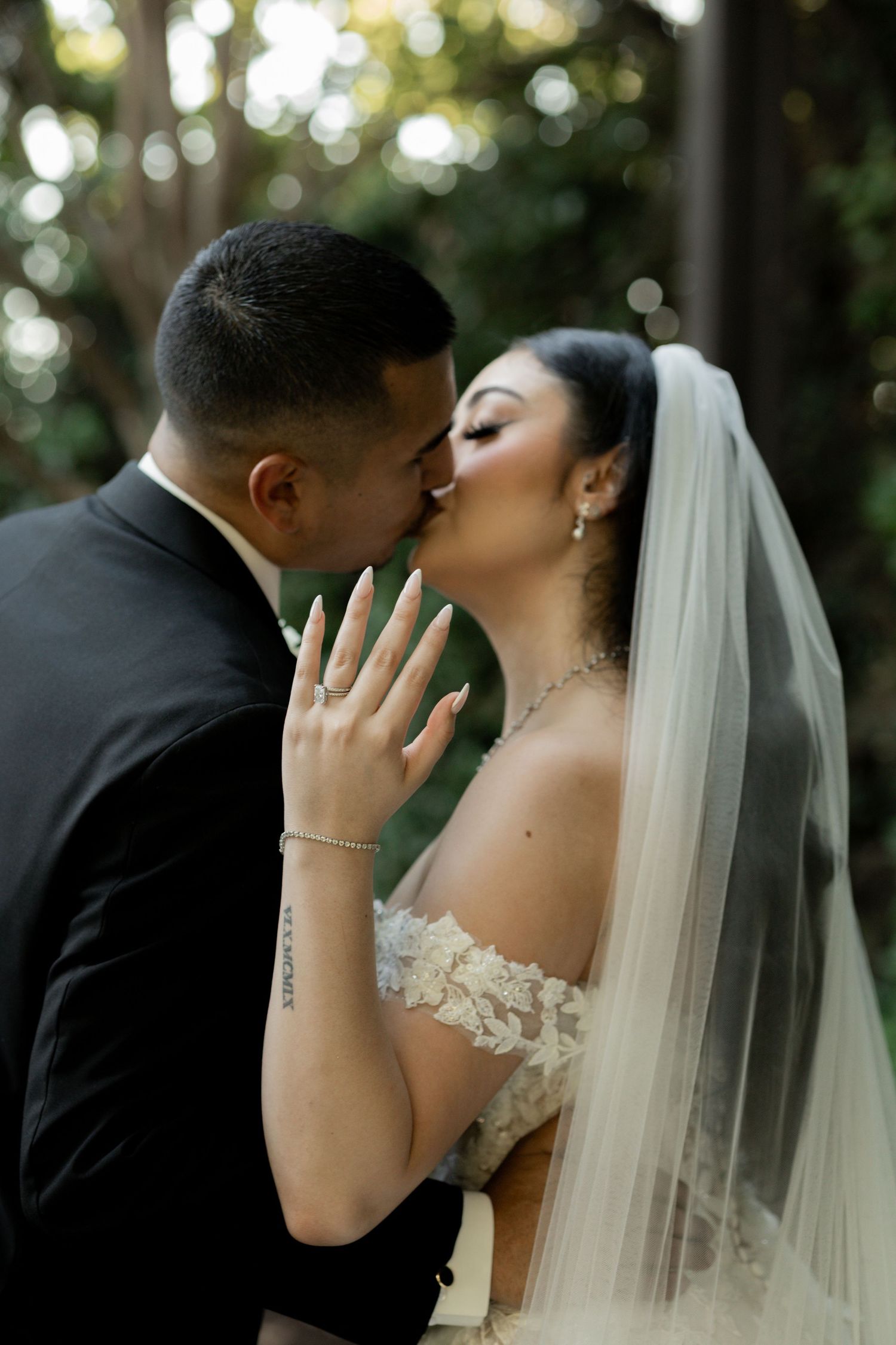 Intimate wedding portrait series captured in natural lighting among trees.