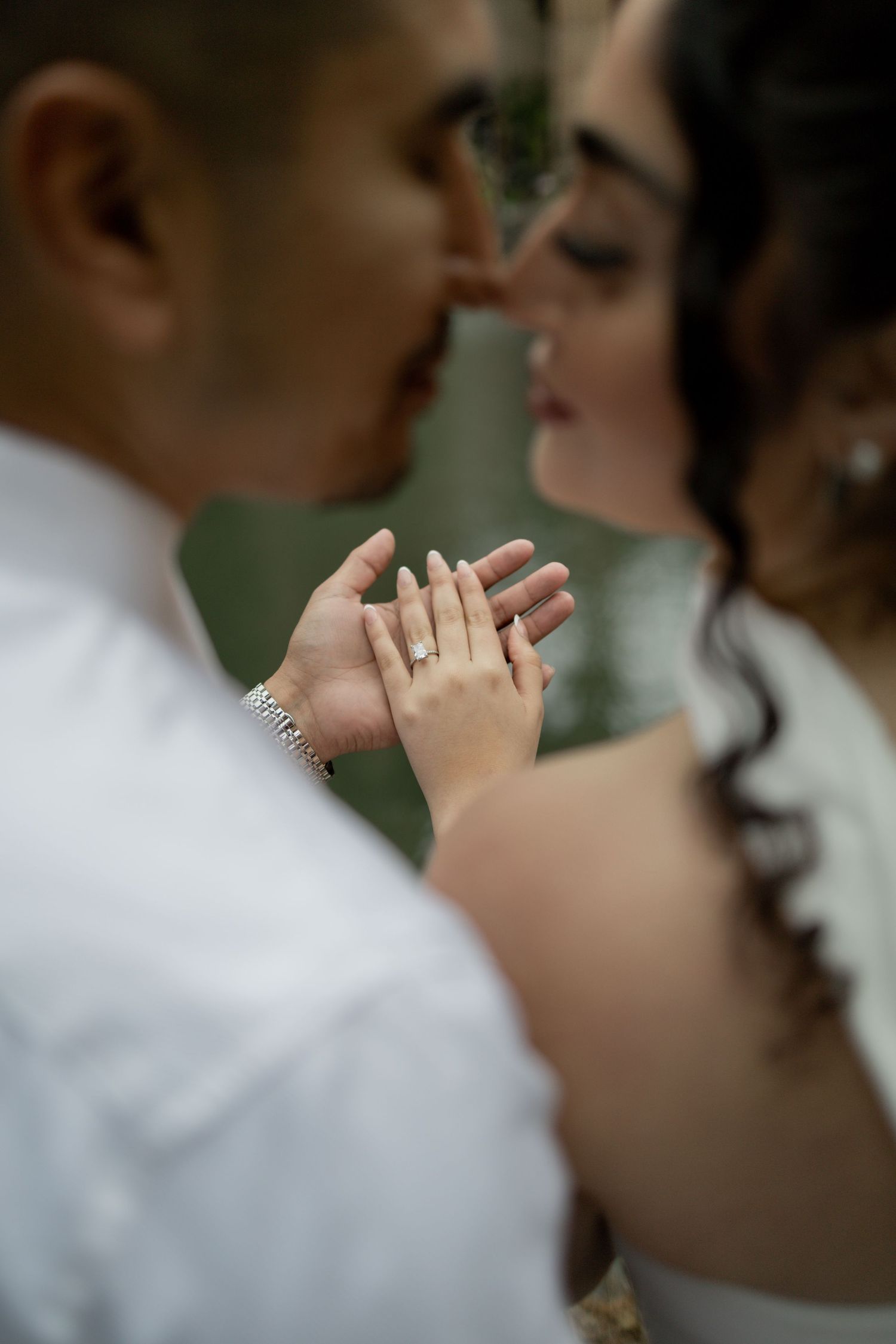 Close-up of hands touching tenderly during an intimate moment.