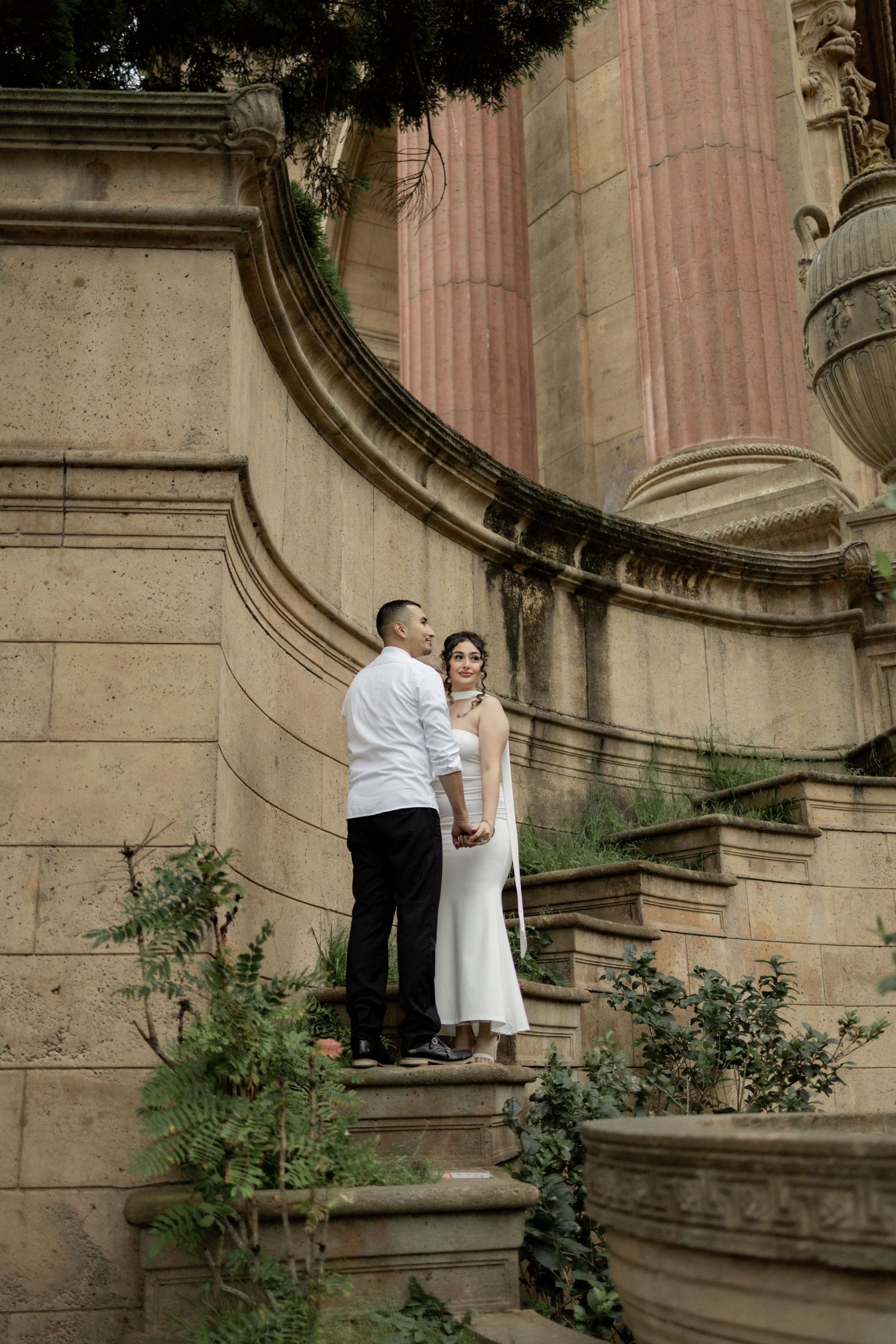 A romantic sequence of photos on stone steps with architectural columns and greenery.