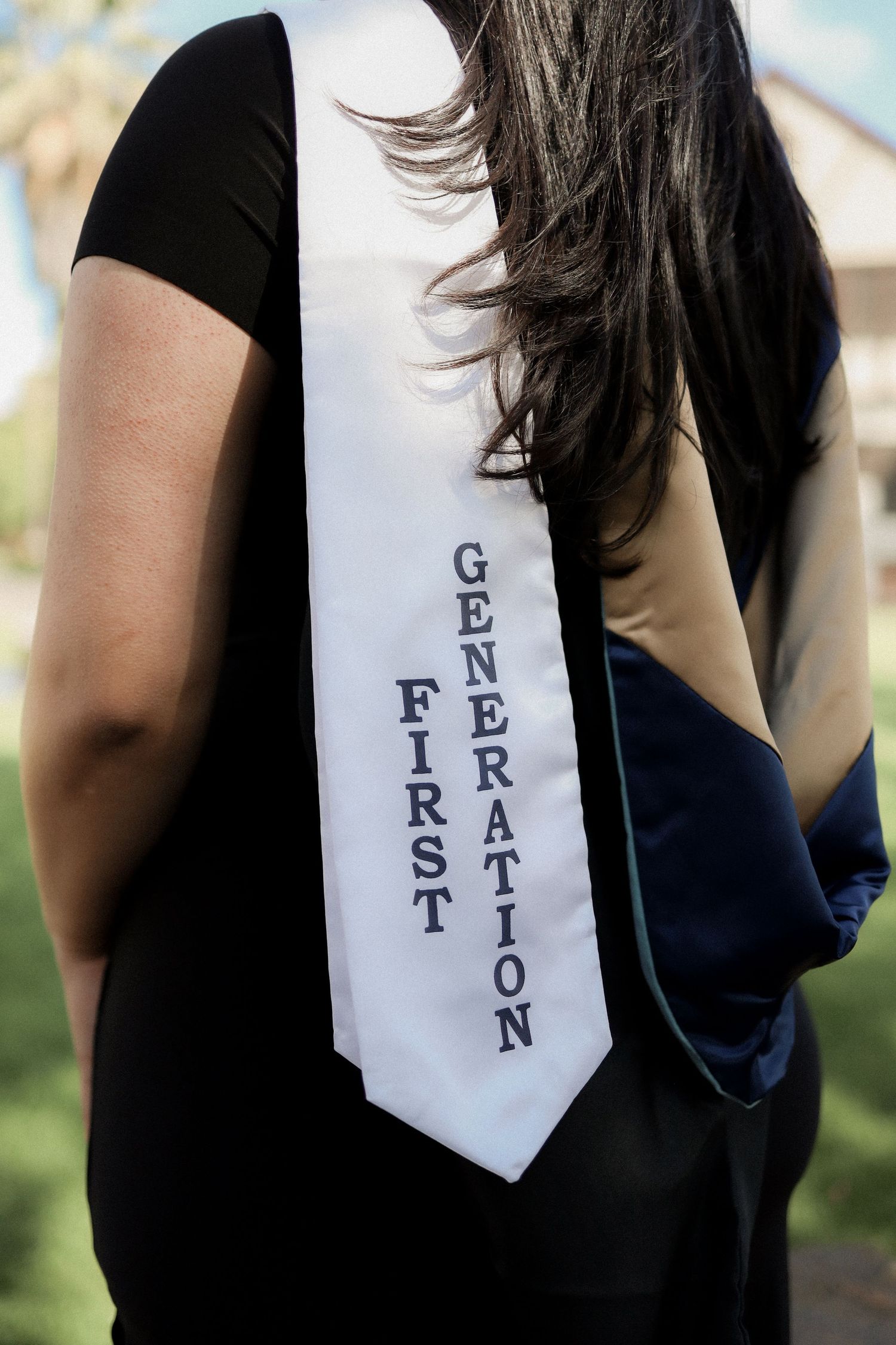 A series of close-up shots showing parts of a black dress with white text fragments on fabric.