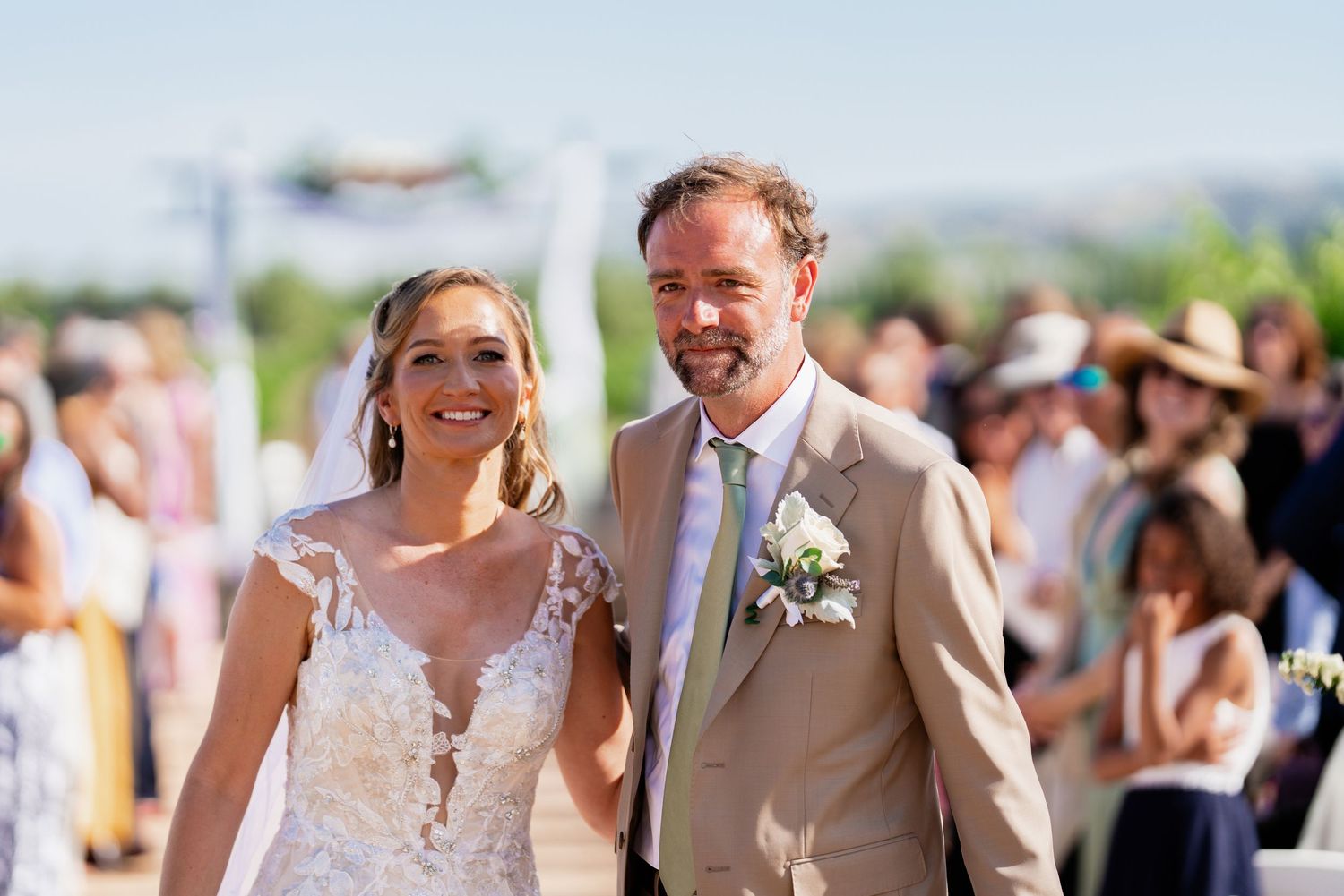 Outdoor vineyard wedding ceremony with mountain views in the background.