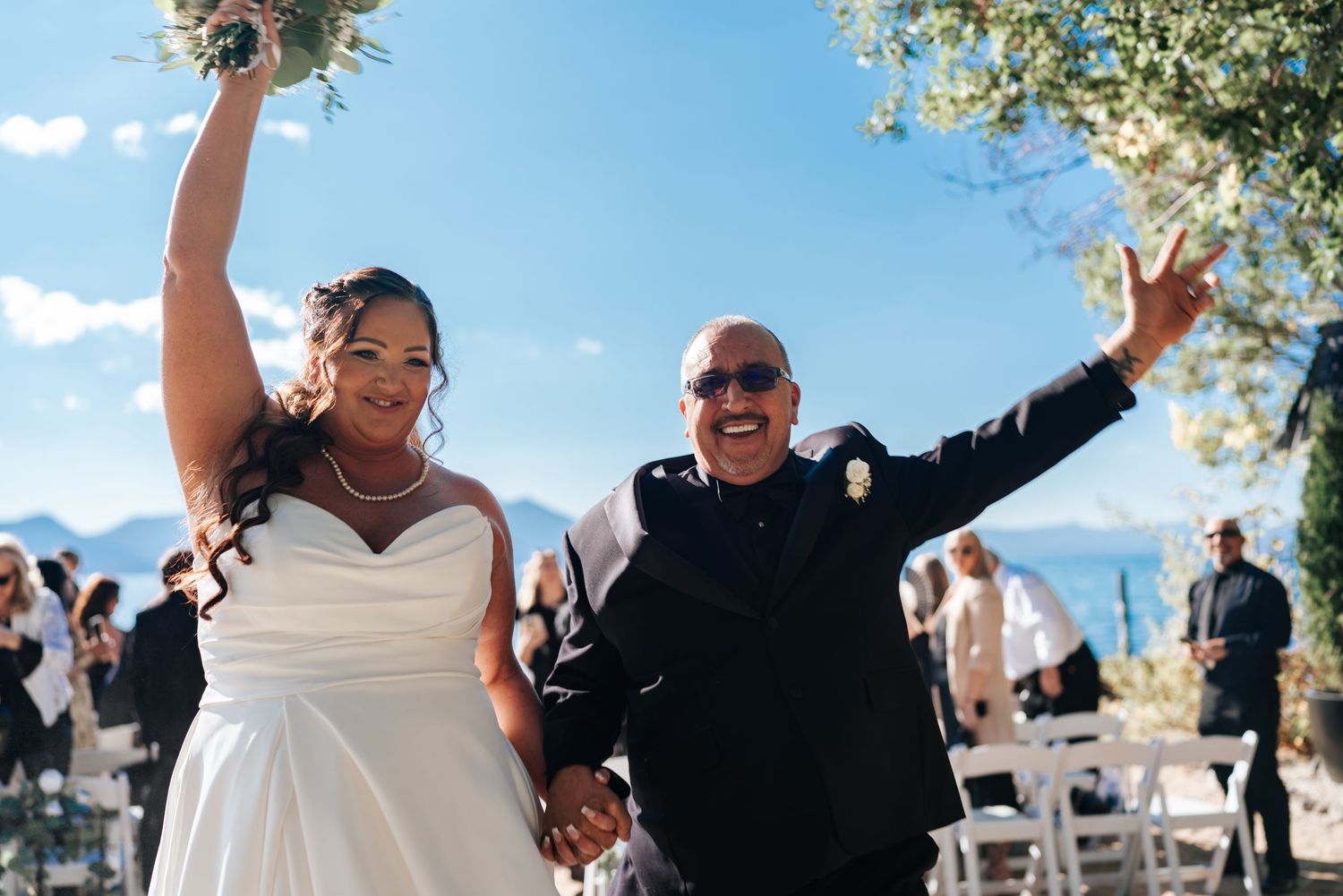 Wedding celebration outdoors with joyful dancing and festivities.