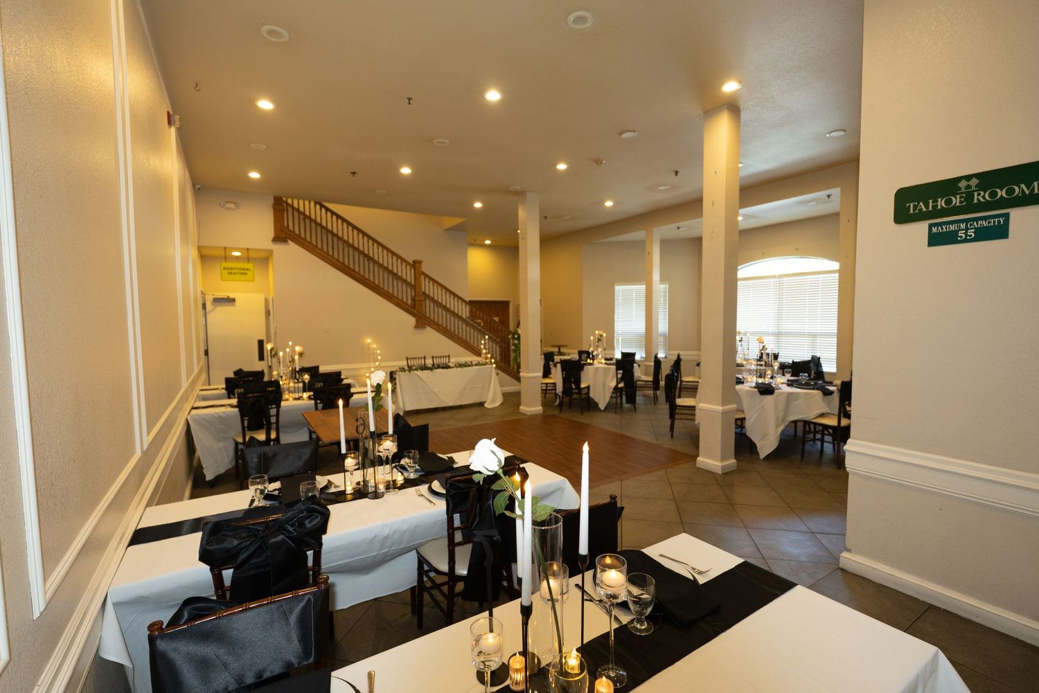 Modern event space interior with white columns and professional lighting setup at Forest Suits Resorts